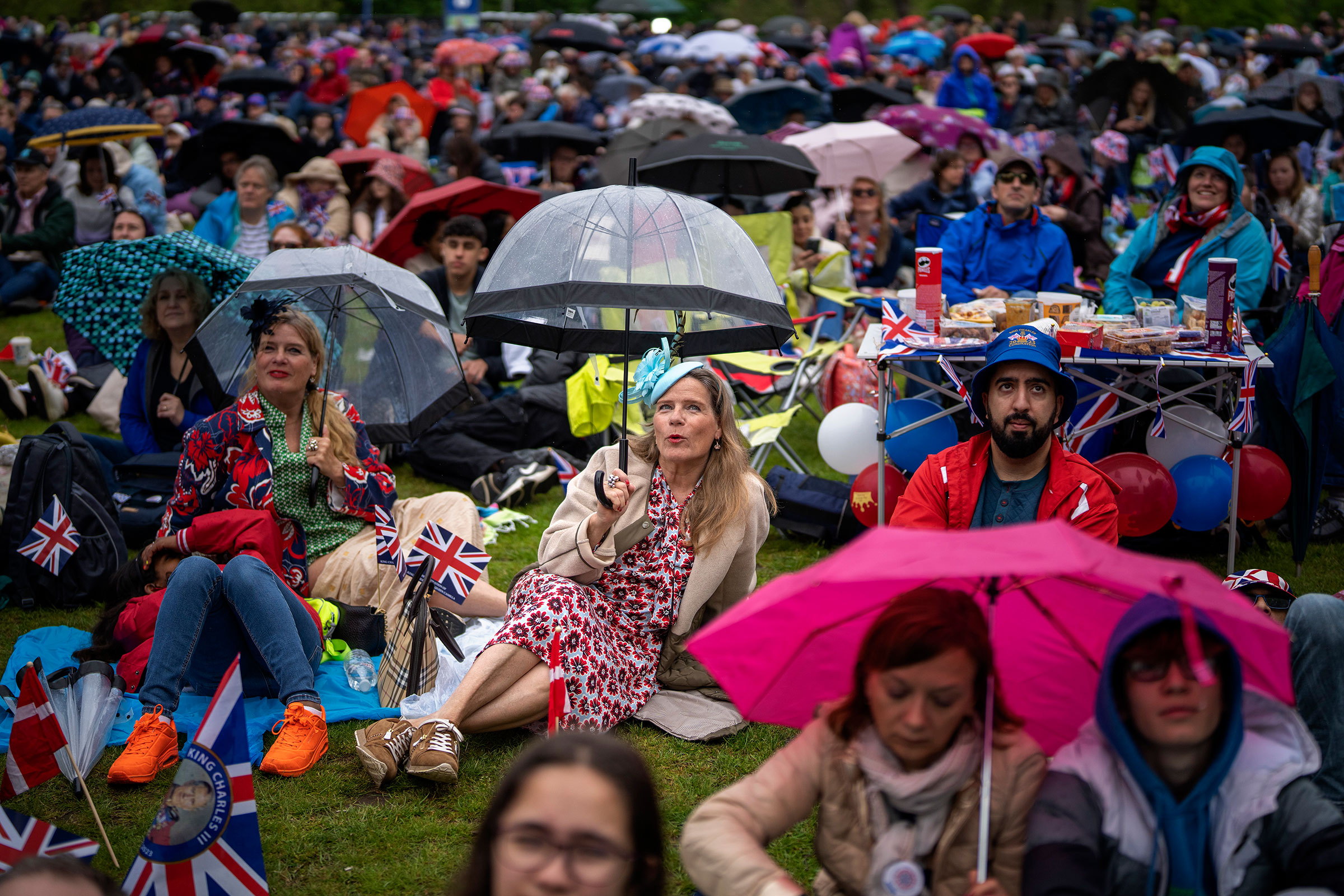 Royal fans watch the Britain's King Charles III coronation ceremony on a screen in Hyde Park.