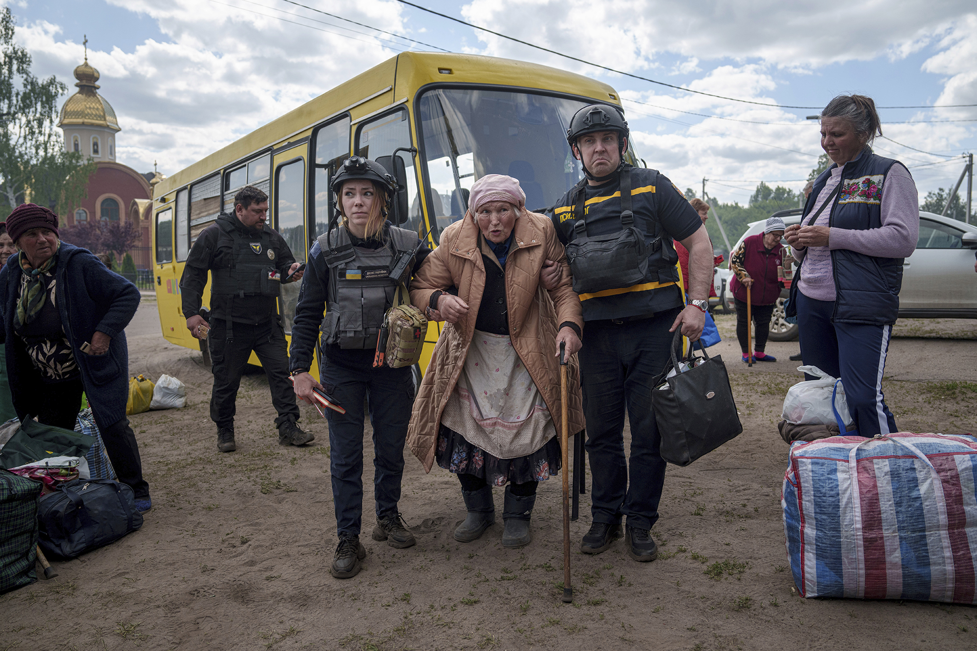 Rescue workers help Liudmila Kalashnik, 88, after evacuation from Vovchansk, Ukraine, on May 12.