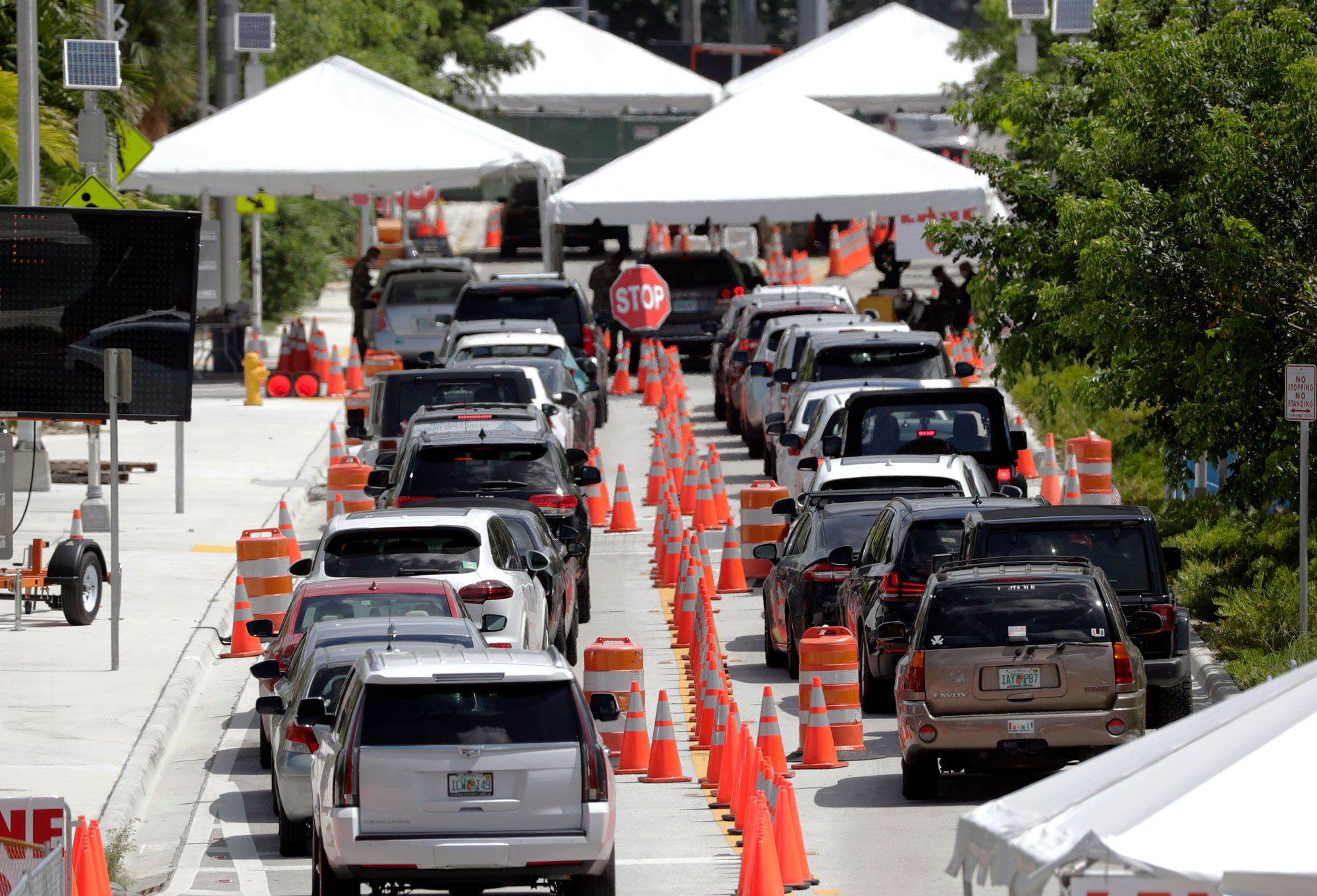 Lines of cars wait at a drive-through coronavirus testing site outside the Miami Beach Convention Center on June 26 in Miami Beach, Florida.