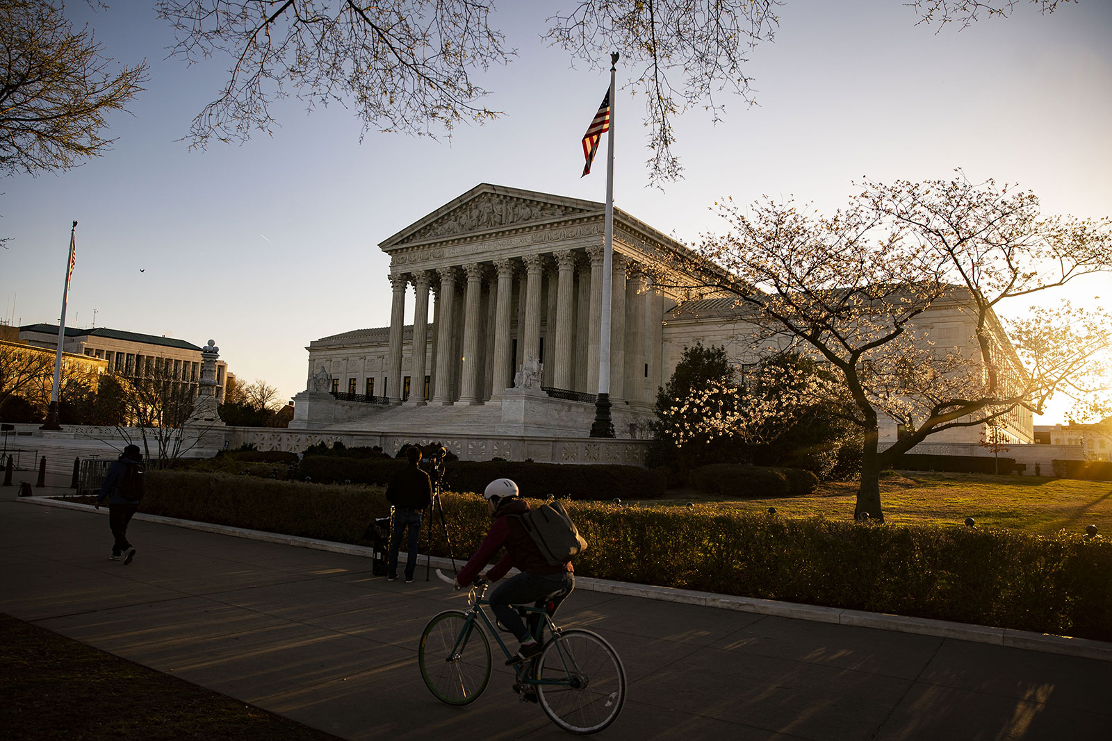 A cyclist rides past the US Supreme Court in Washington, DC, on March 21.