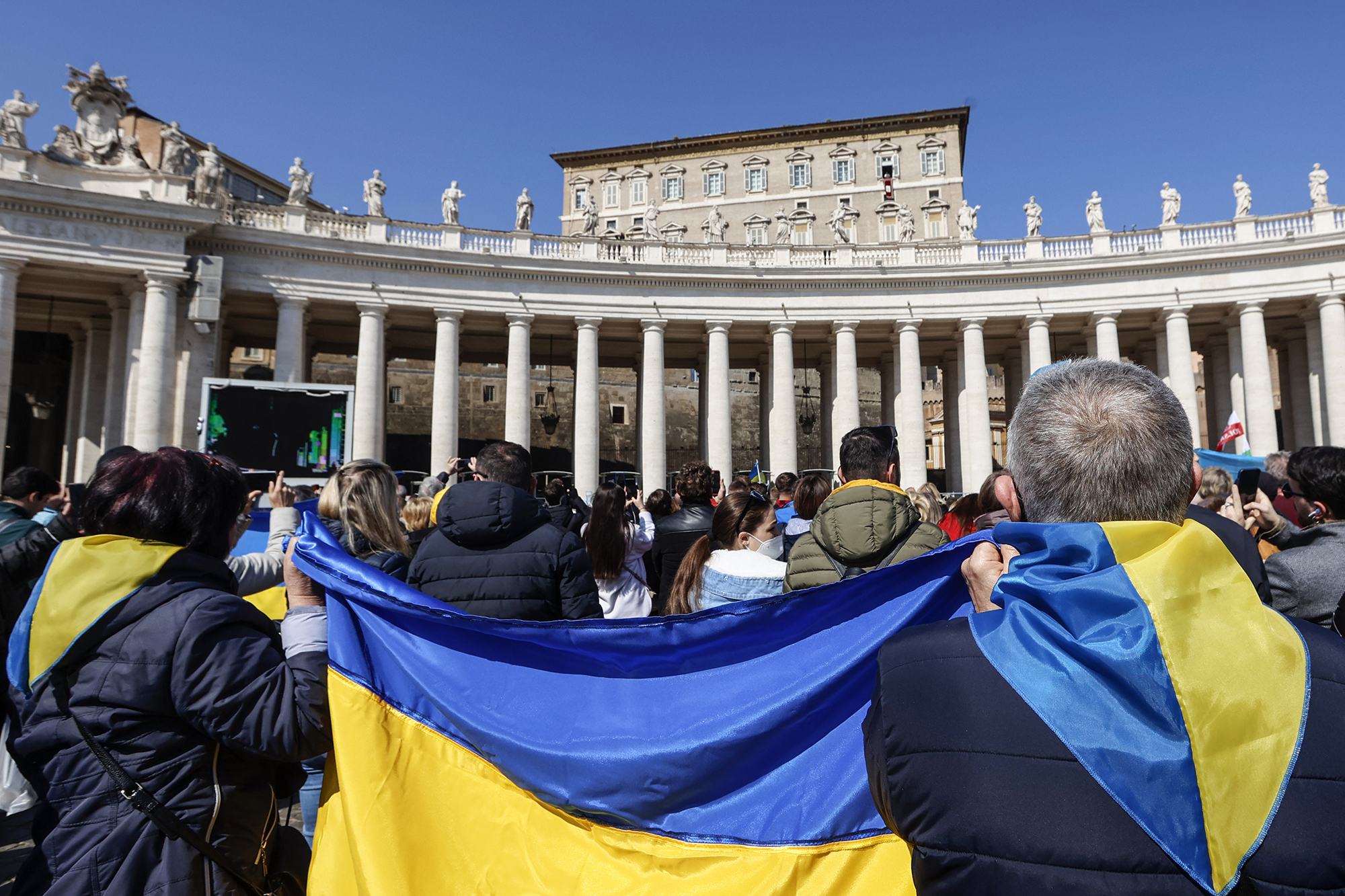 People hold a Ukrainian flag in St. Peter's Square at the Vatican on March 6. 