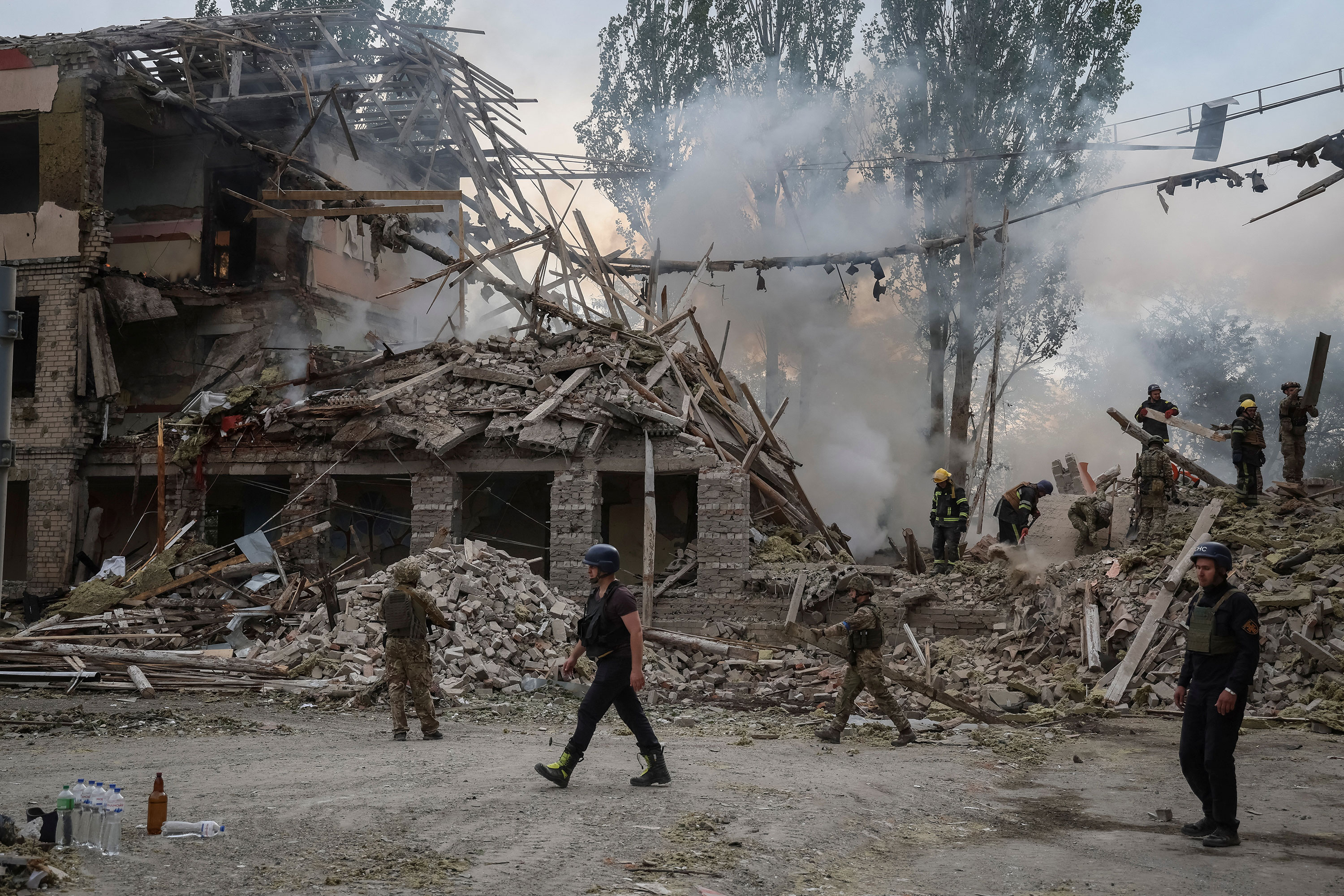 Rescuers and servicemen work at a damaged school building in Kramatorsk, Ukraine, on July 21.