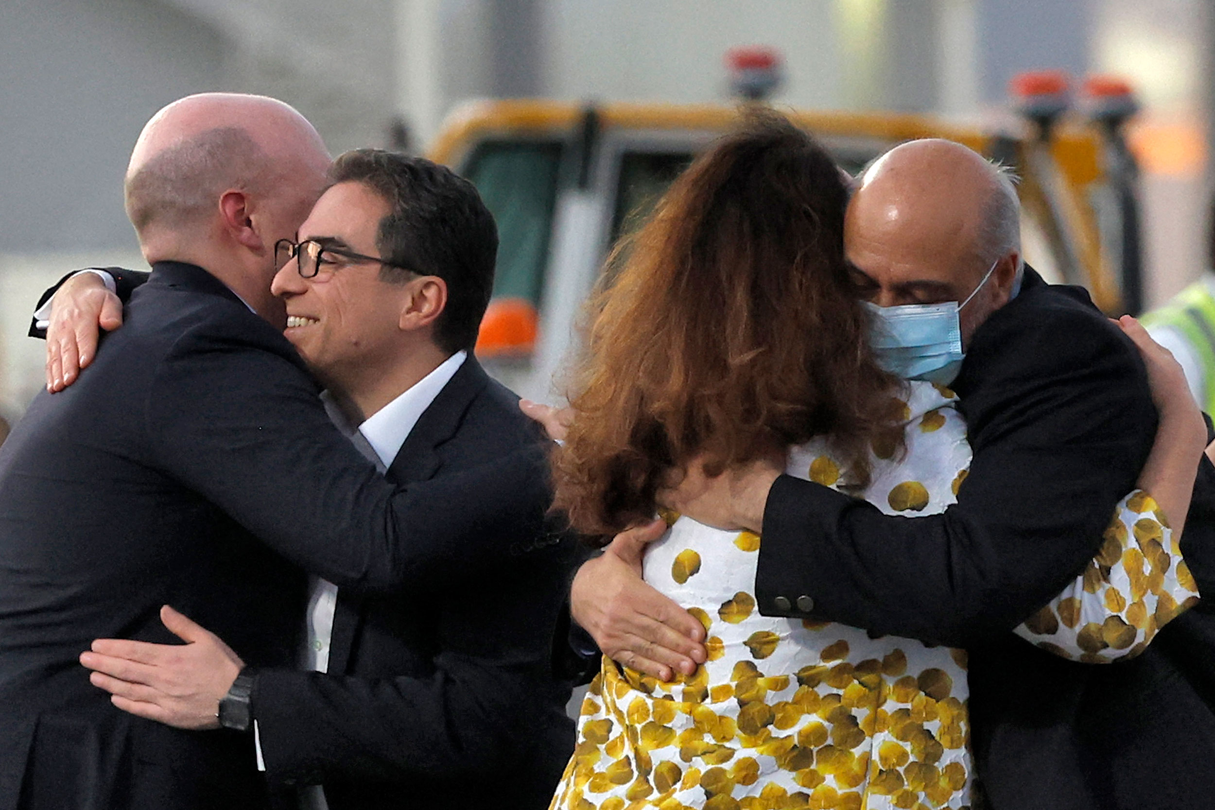 US citizens Siamak Namazi, second from left, and Morad Tahbaz, right, are embraced after disembarking from a jet in Doha, Qatar, on September 18, 2023.