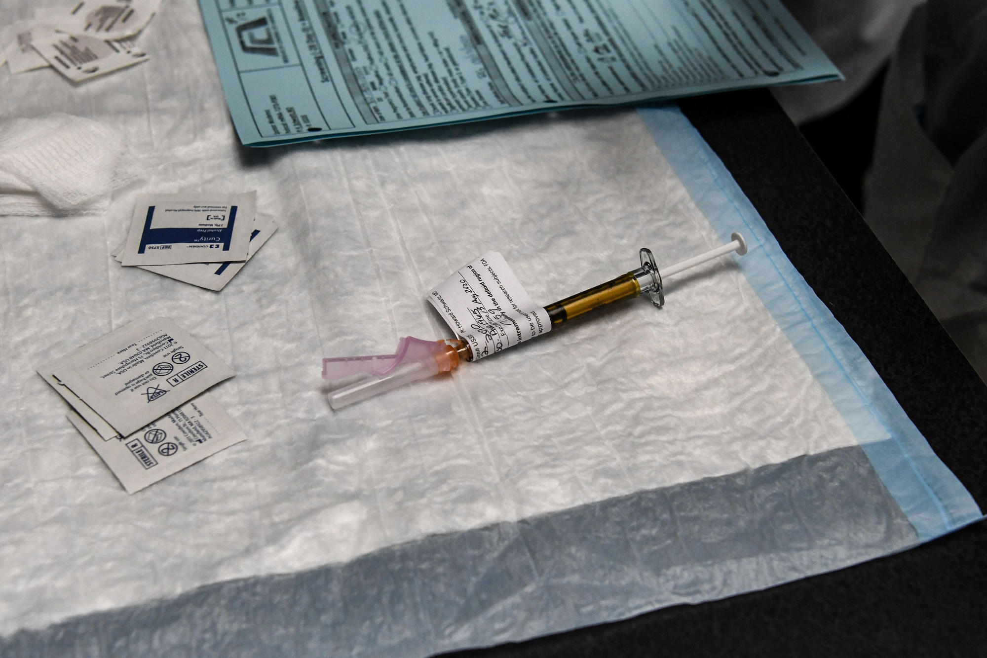 An injection is prepared as a part of a vaccine trial at the Research Centers of America in Hollywood, Florida, on August 13.