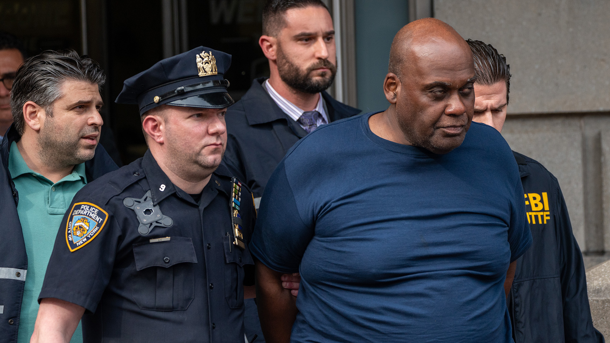 Suspected Brooklyn subway shooter Frank James is escorted out of the 9th Precinct by law enforcement officials after being arrested in New York's East Village neighborhood on Wednesday April 13. 