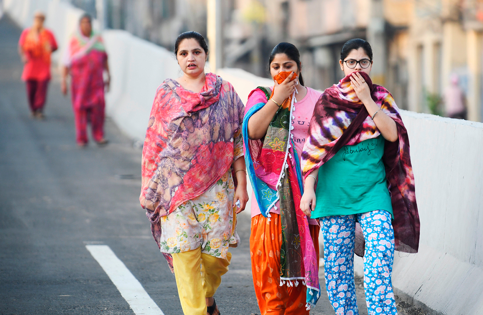 Women walk early in the morning along a road on the outskirts of Amritsar, India on June 16.