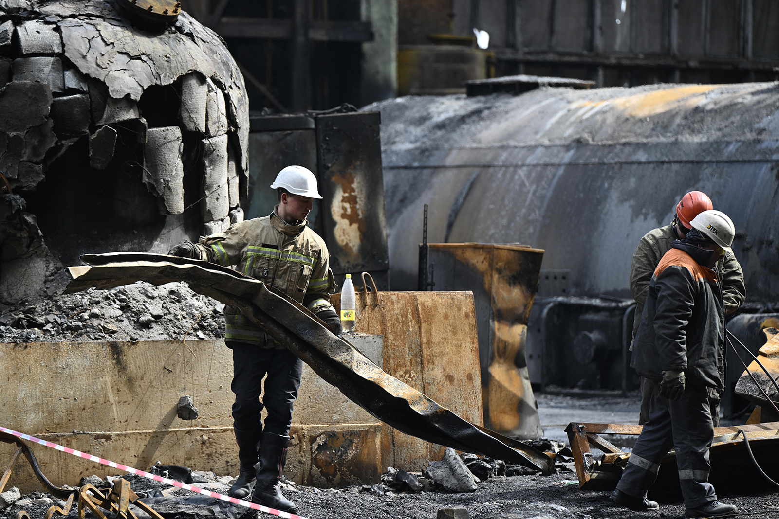 Rescuers and workers clean debris in a turbine hall at a power plant of energy provider DTEK, destroyed after an attack, in an undisclosed location in Ukraine on April 19. 