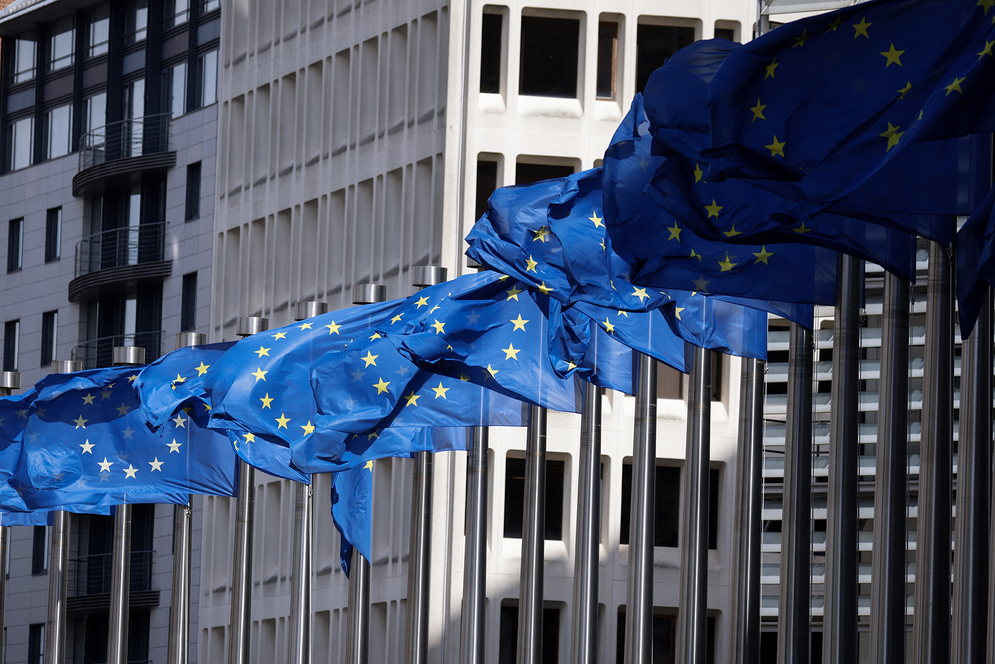 European Union flags fly outside the European Commission building in Brussels, Belgium, on April 12.