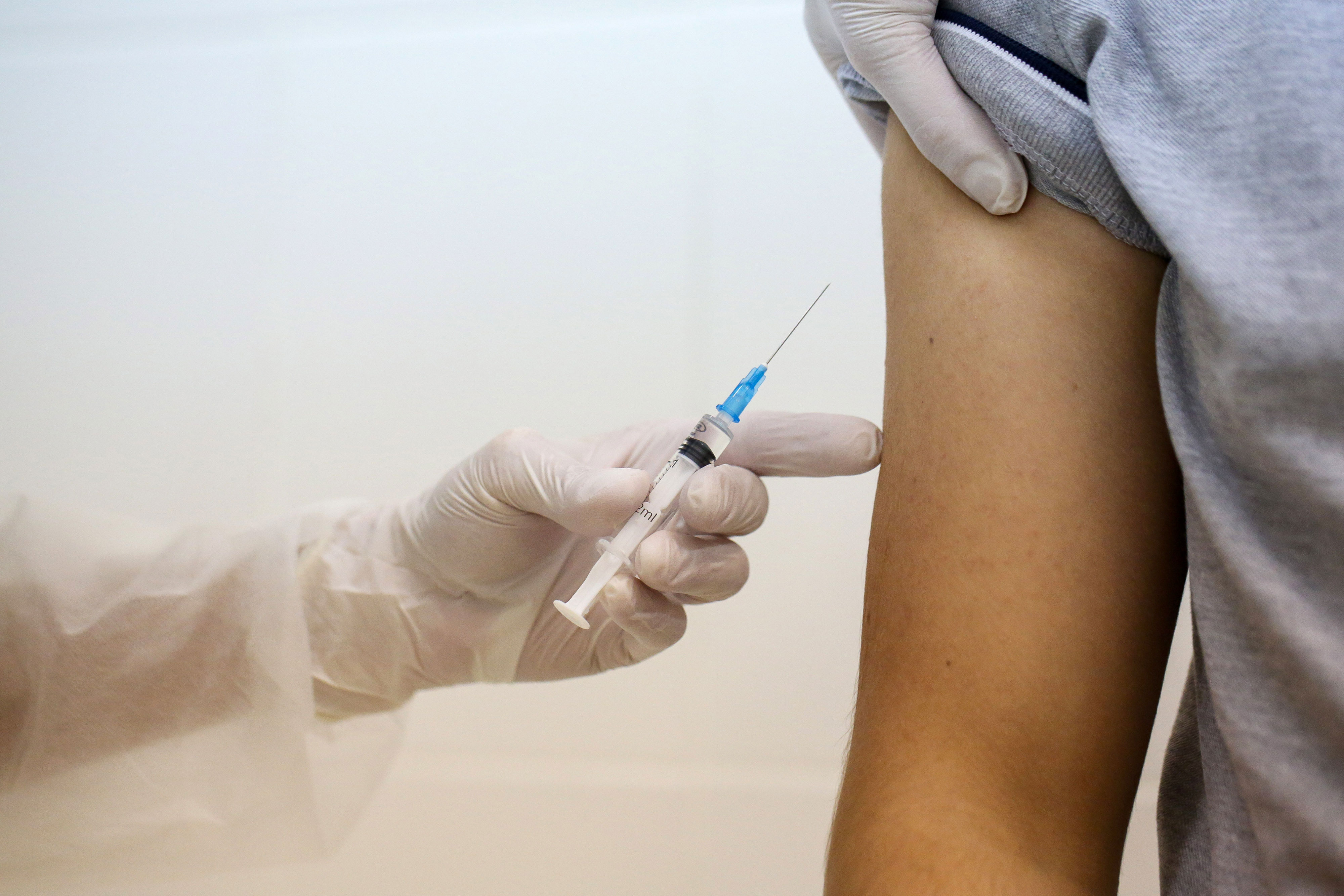 A health worker in Moscow prepares to inject the Sputnik V coronavirus vaccine into a patient's arm during a trial on September 23. The vaccine was developed by the Gamaleya Research Institute of Epidemiology and Microbiology and the Russian Direct Investment Fund.