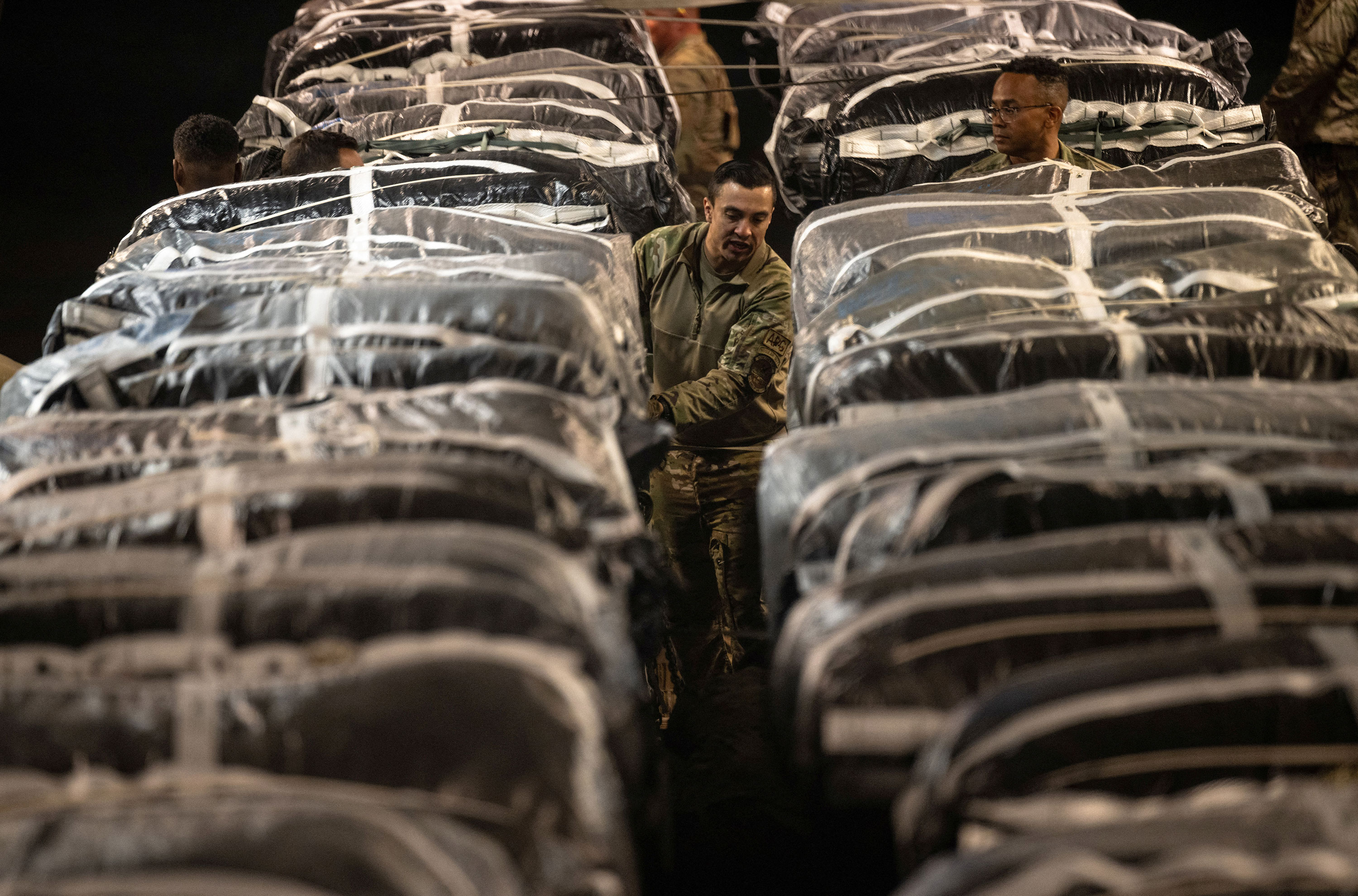 US service members secure humanitarian aid, bound for airdrop over Gaza, onto a cargo aircraft on March 1. 