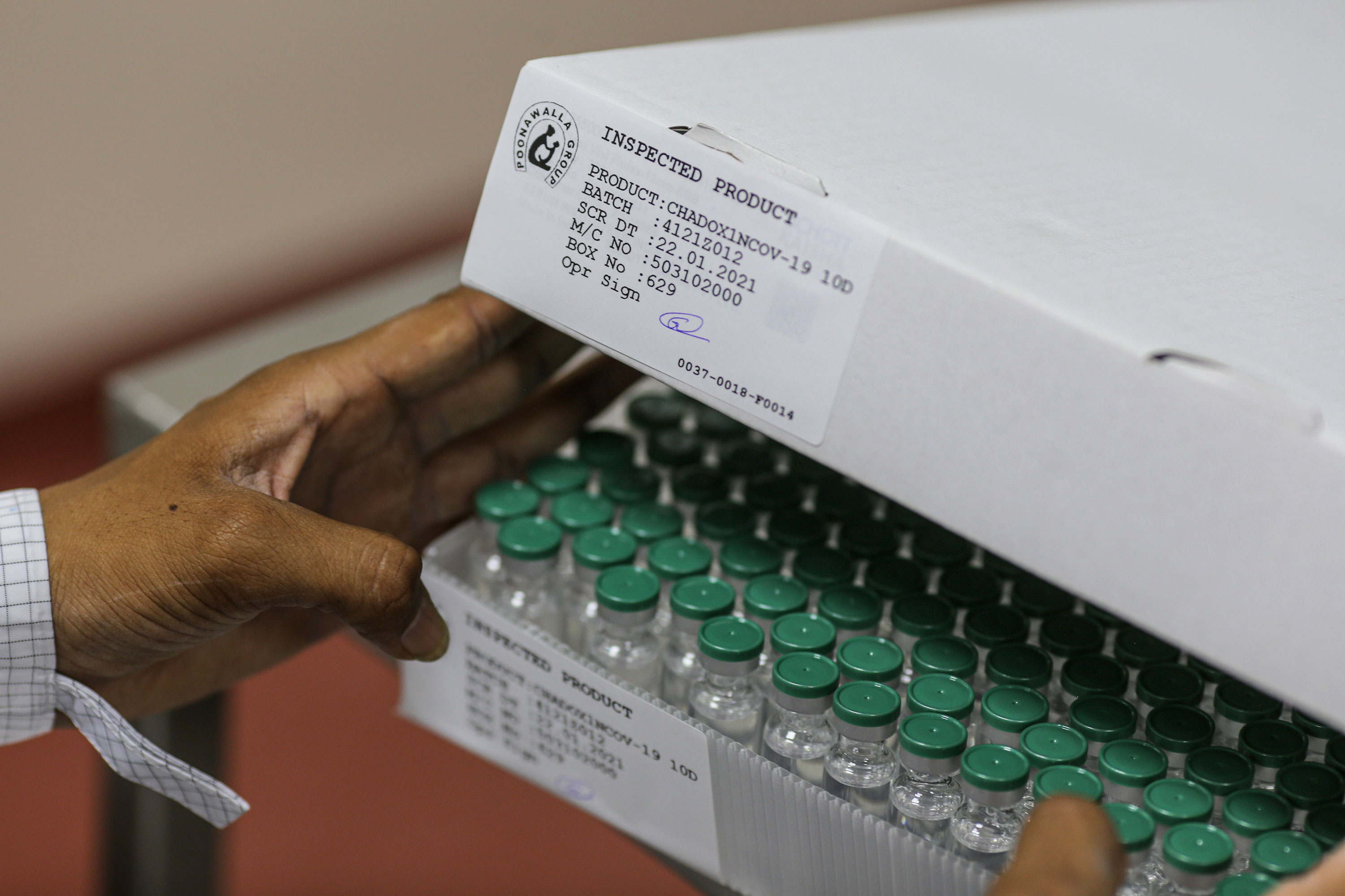 Vials of the Oxford/AstraZeneca vaccine are packaged on the production line at the Serum Institute in Pune, India, on January 22.