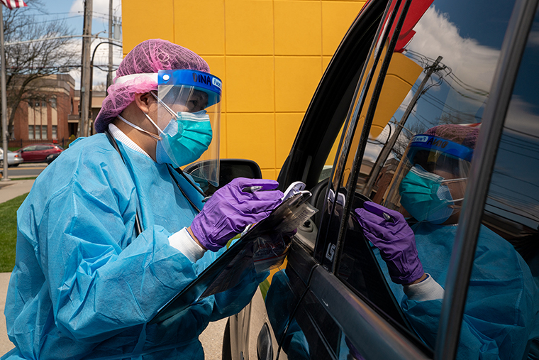 Medical staff at an urgent care clinic preform coronavirus testing in the clinic parking lot on Wednesday, April 22, in the Staten Island borough of New York City. T