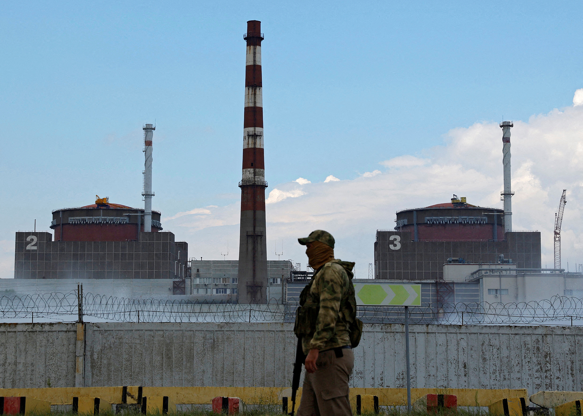 A serviceman with a Russian flag on his uniform stands guard near the Zaporizhzhia nuclear plant on August 4.