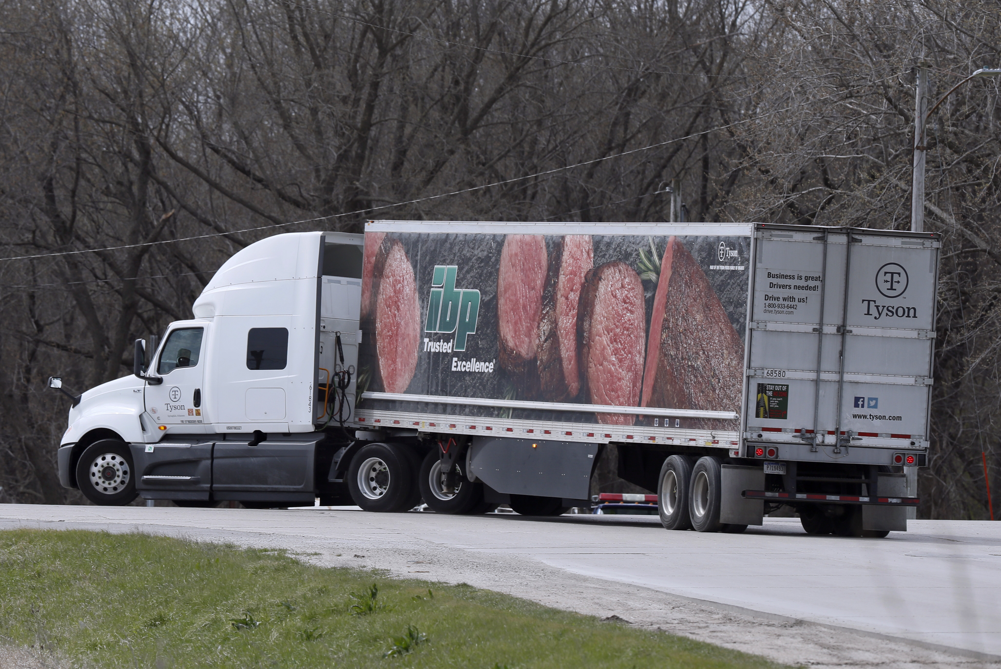 A truck turns onto a highway after leaving the Tyson Foods pork plant in Perry, Iowa, on April 22.