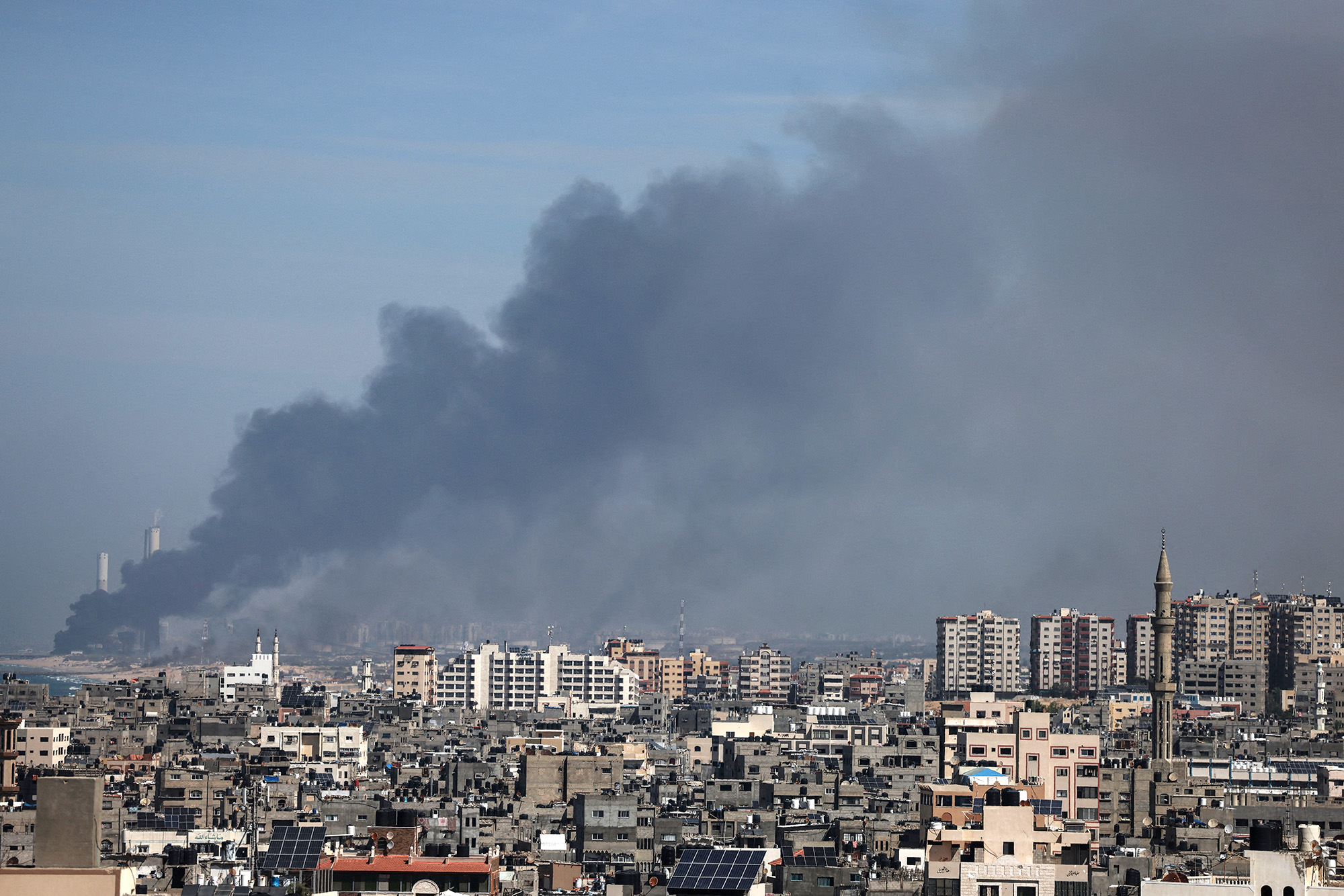 Smoke billows over the Israeli side of the border following a series of early morning rocket attacks from the Gaza Strip into Israel on October 7.