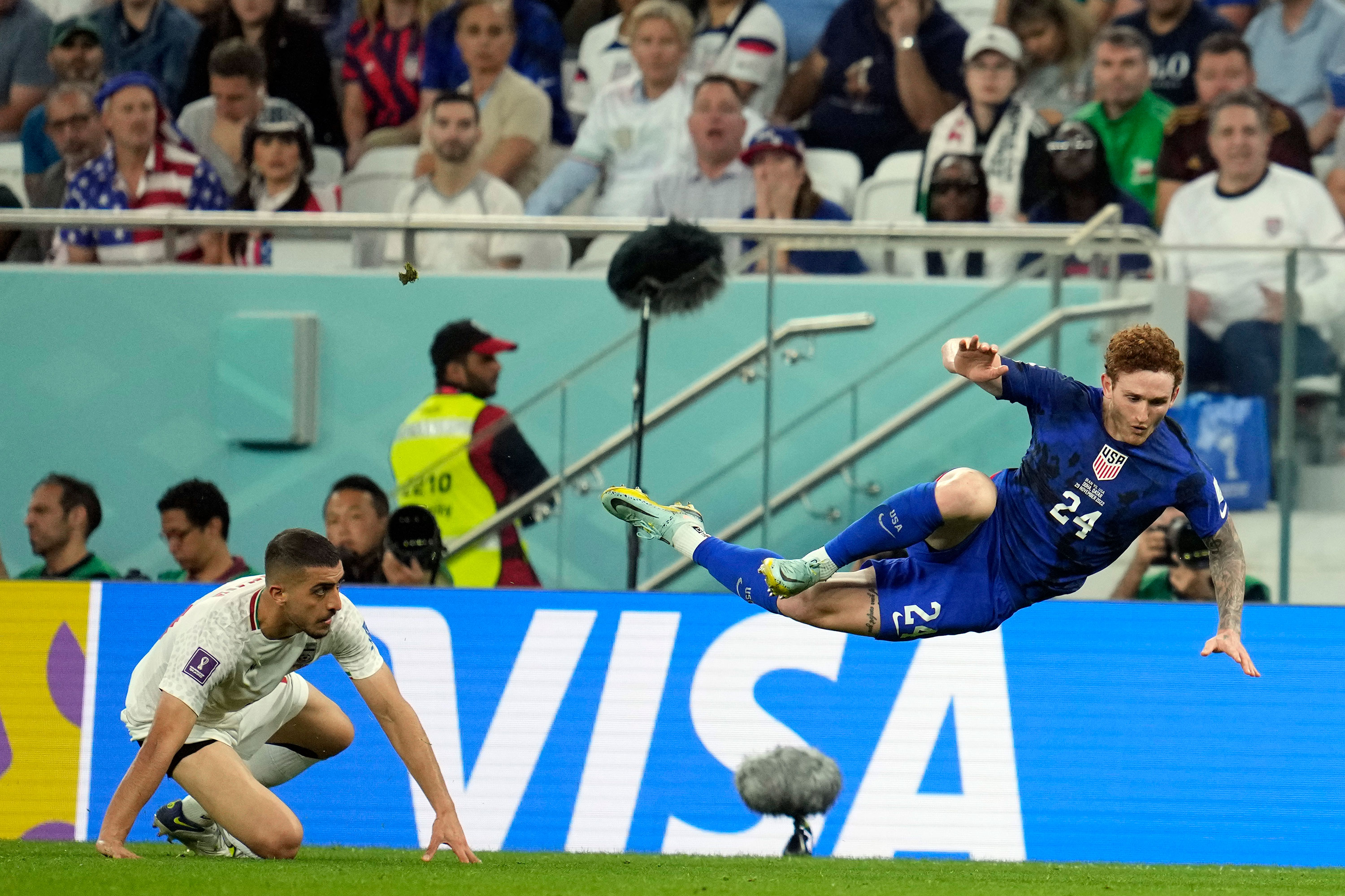 United States' Josh Sargent (24) is upended by Iran's Majid Hosseini during the World Cup group B soccer match between Iran and the United States at the Al Thumama Stadium in Doha, Qatar, Tuesday, Nov. 29, 2022. (AP Photo/Ashley Landis)
