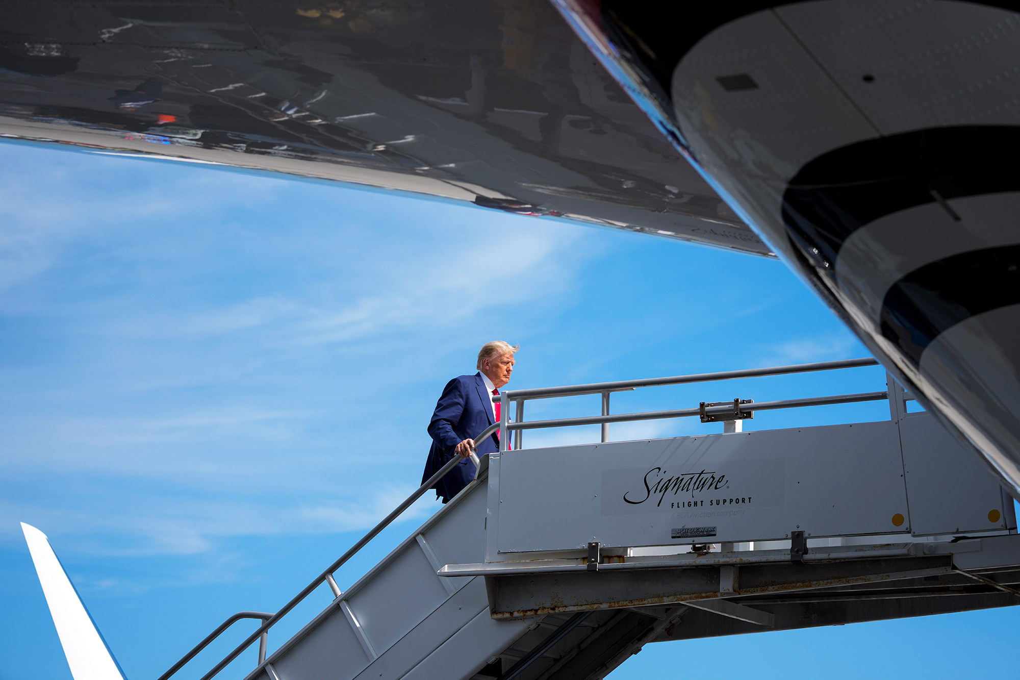 Trump boards his plane at Miami International Airport before heading to Newark, New Jersey, on June 13, 2023. 