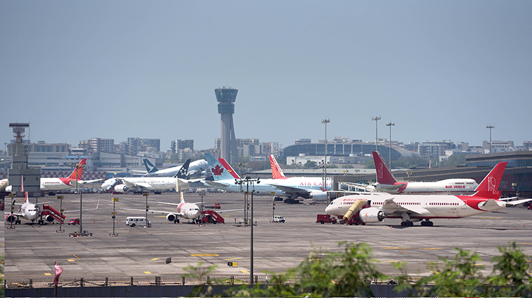 Planes are seen parked at Mumbai airport, on  Saturday, March 21, in Mumbai, India. 