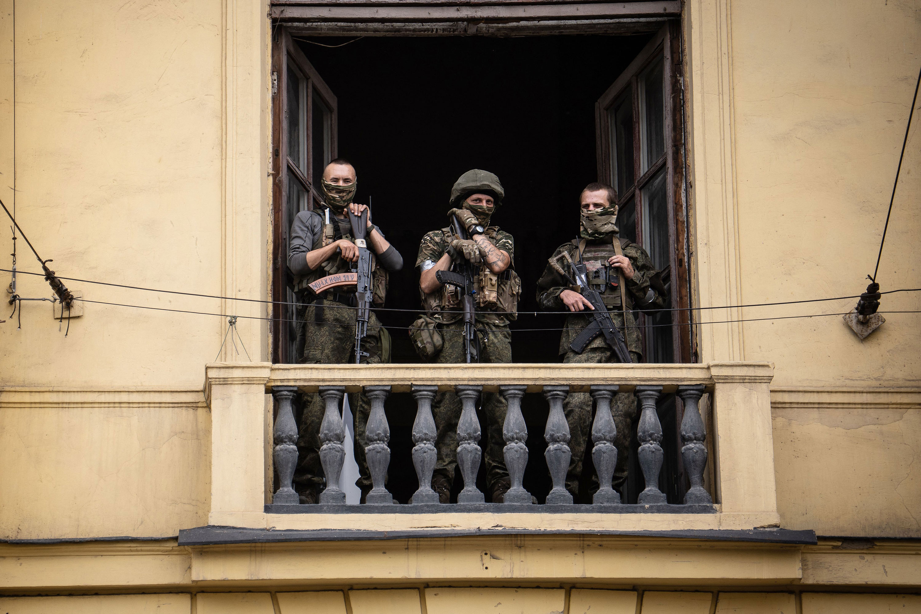 Members of the Wagner group stand on the balcony of a building in Rostov-on-Don on Saturday. 