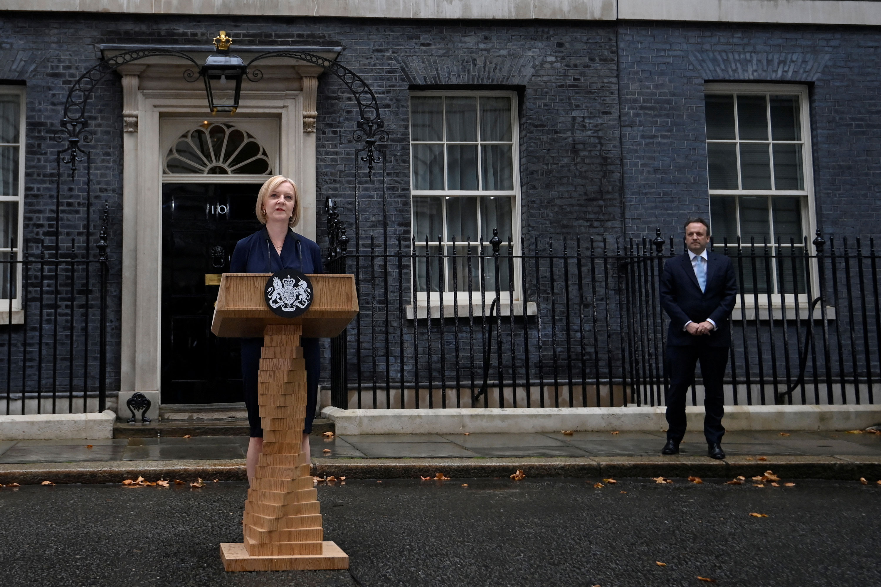 New British Prime Minister Liz Truss delivers a speech outside Downing Street as her husband Hugh O'Leary listens on Tuesday.