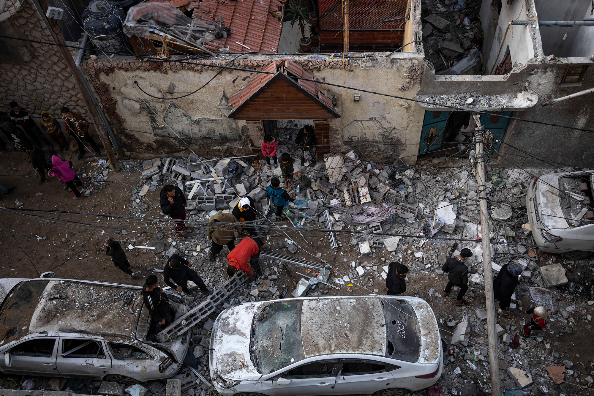 Palestinians look at the destruction after an Israeli strike in Rafah, Gaza, on February 9.