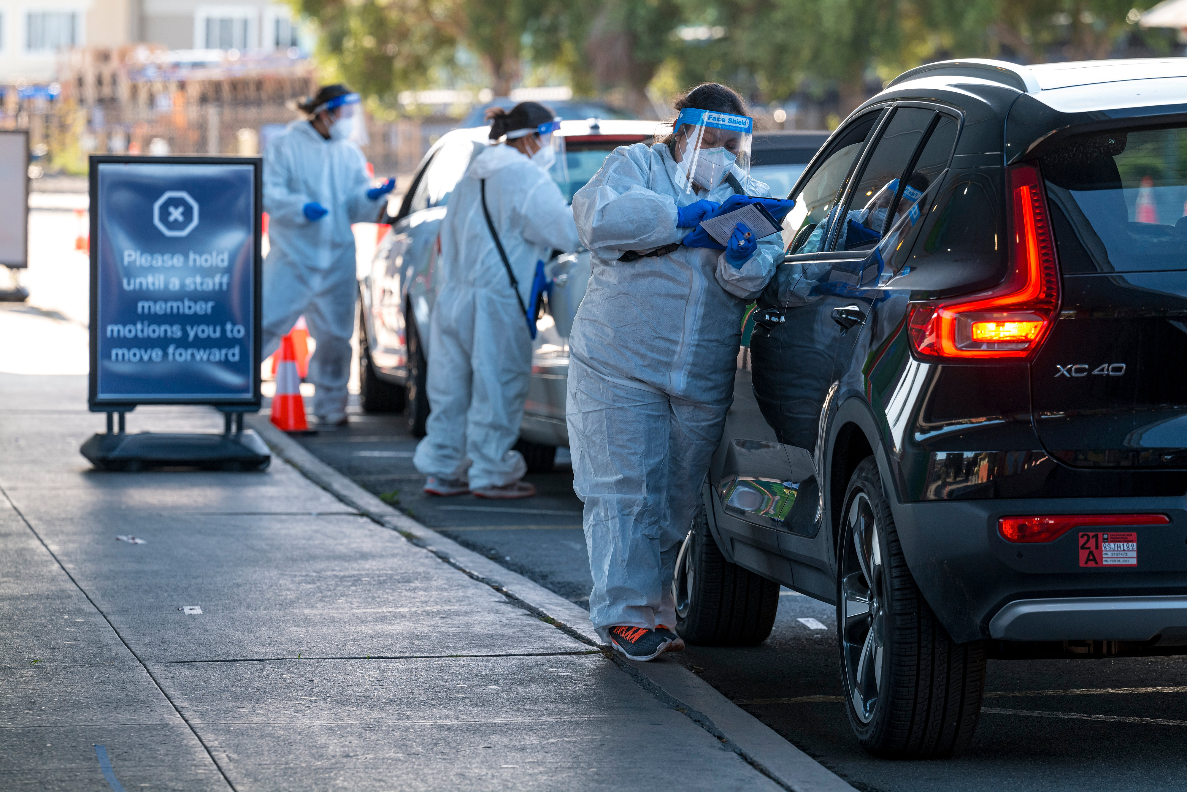 Medical workers administer Covid-19 tests at a drive-thru testing site in San Francisco, California, on Thursday, November 19. 