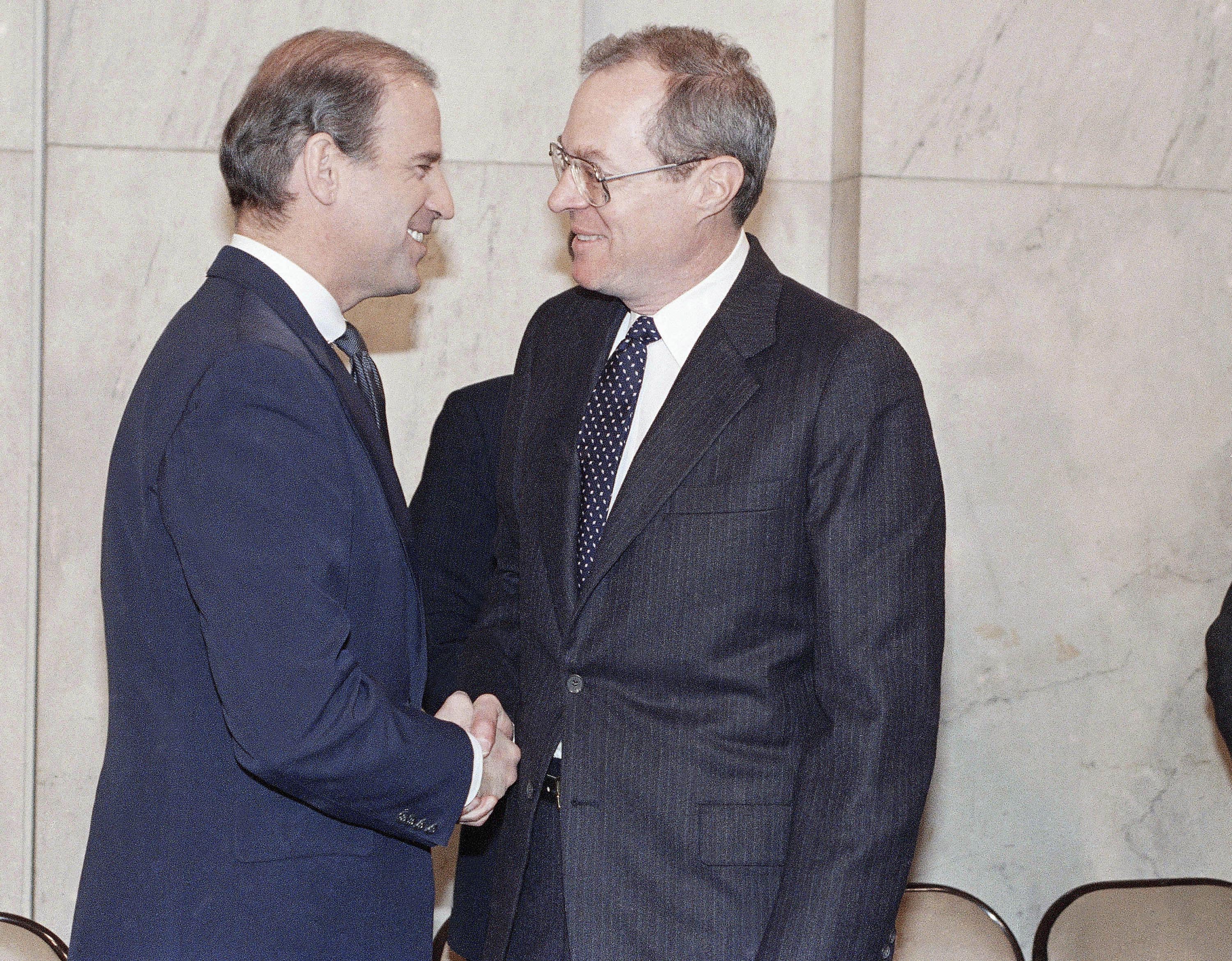 Supreme Court nominee Anthony M. Kennedy, right, shakes hands with then-Senate Judiciary Committee Chairman Joseph Biden of Delaware before the start to his confirmation hearing at Capitol Hill in December 1987.