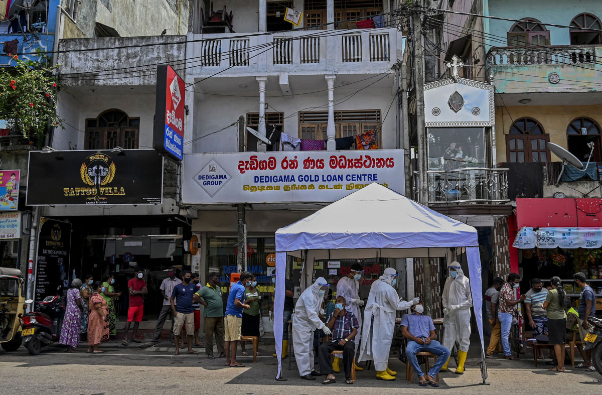 Health workers wearing protective gear collect swab samples from residents to test for Covid-19 in Colombo, Sri Lanka on May 4.