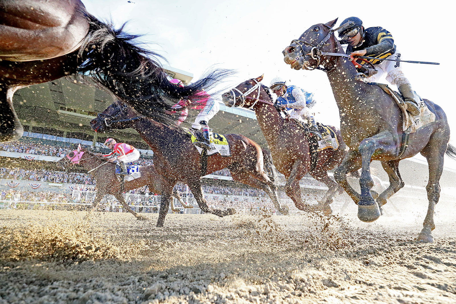 Horses and their jockeys thunder down the track during the 2019 Belmont Stakes in Elmont, New York.