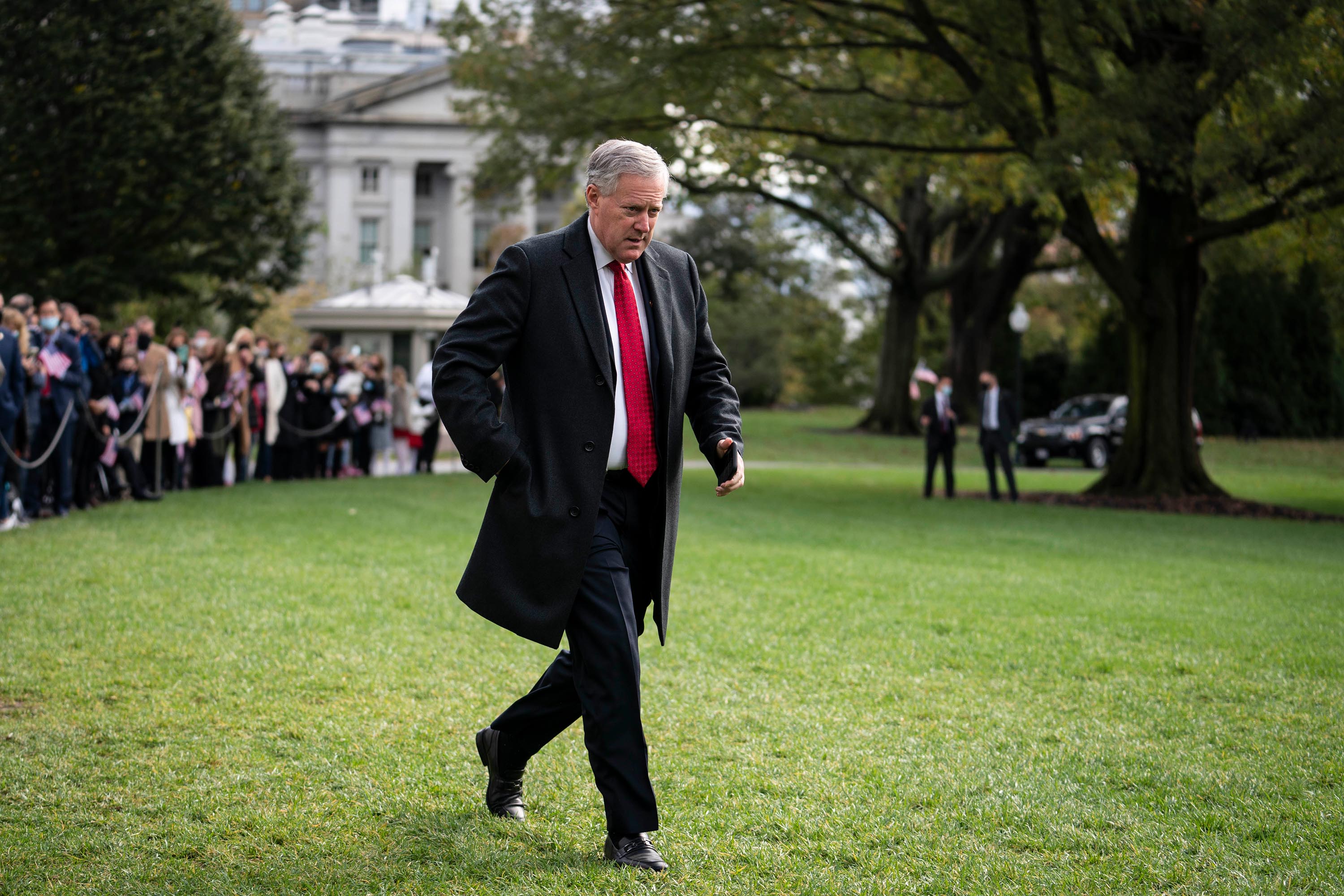 Then White House Chief of Staff Mark Meadows walks along the South Lawn of the White House on October 30, 2020.