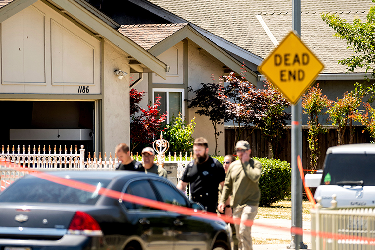 Emergency responders leave a home, rear, being investigated in connection to a shooting at a Santa Clara Valley Transportation Authority (VTA) facility, Wednesday, May 26, in San Jose, California.. 