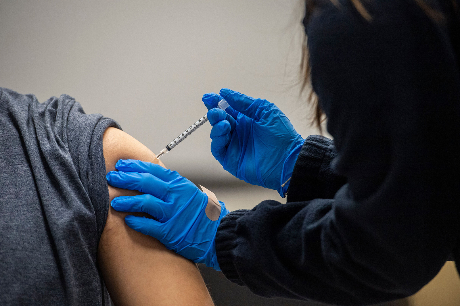 A man is inoculated with the Pfizer-BioNTech Covid-19 vaccine at La Colaborativa in Chelsea, Massachusetts on February 16.