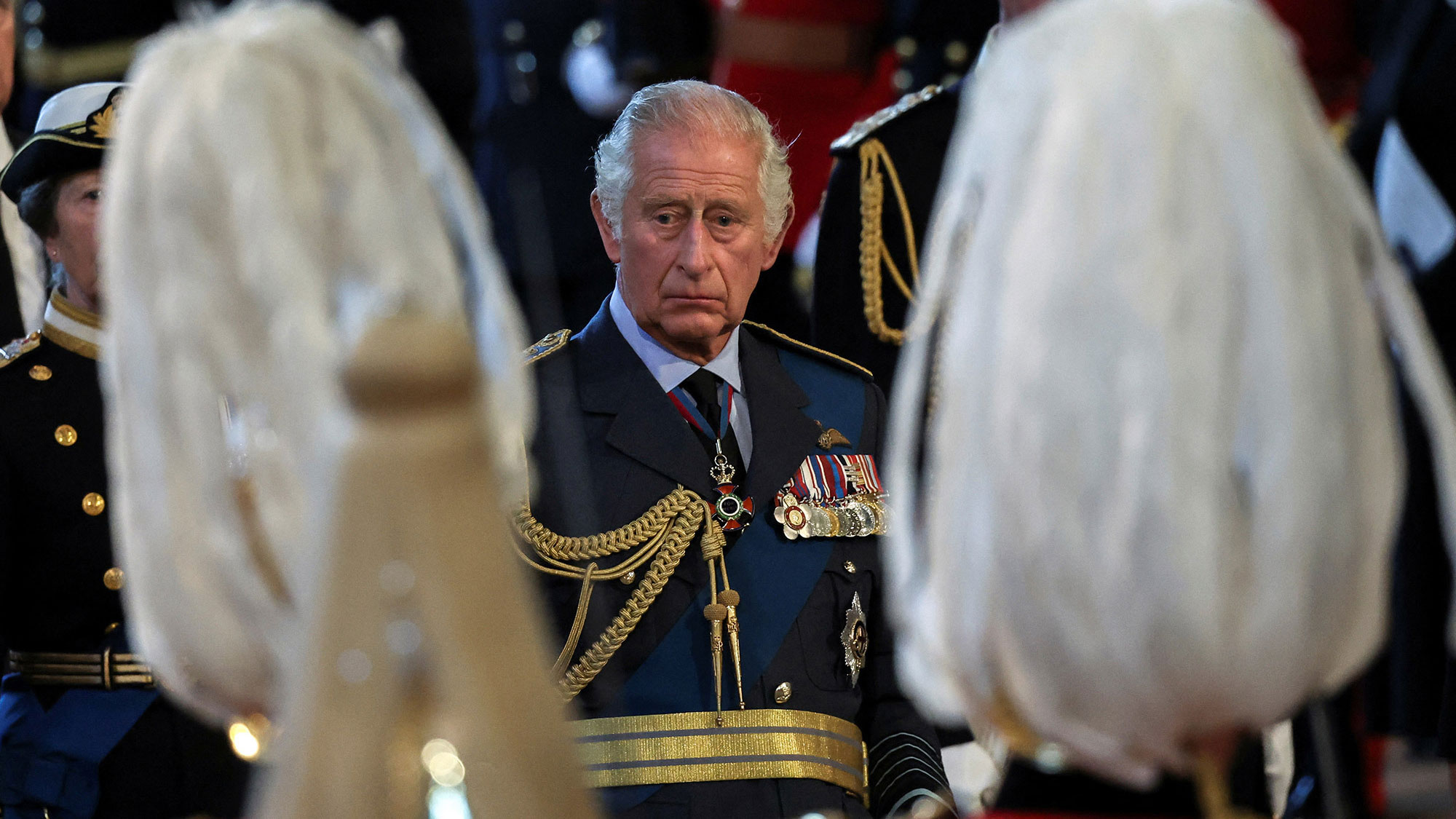 The King watches his mother's coffin arrive at Westminster Hall.