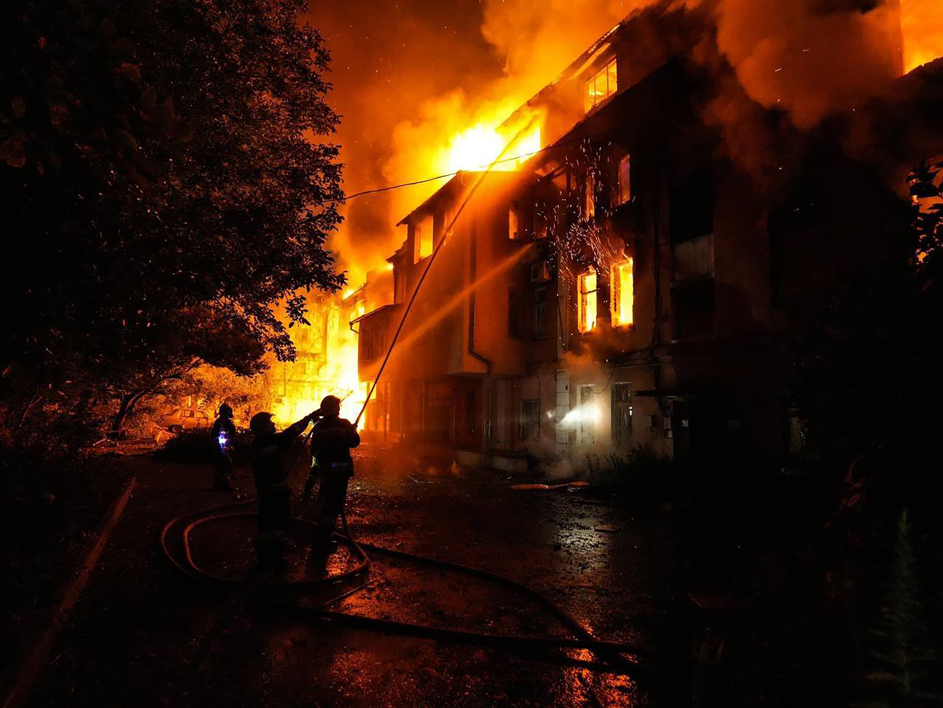 Firefighters extinguish a fire at a damaged house after attacks in Odesa, Ukraine, on July 19.