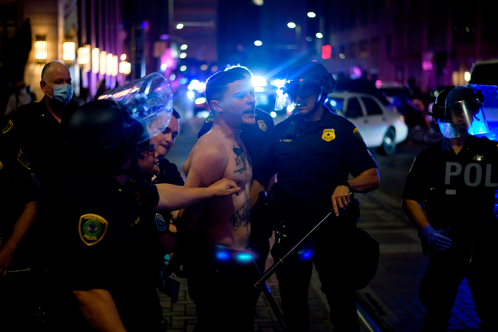 A protester is detained by police in Houston, on May 29.