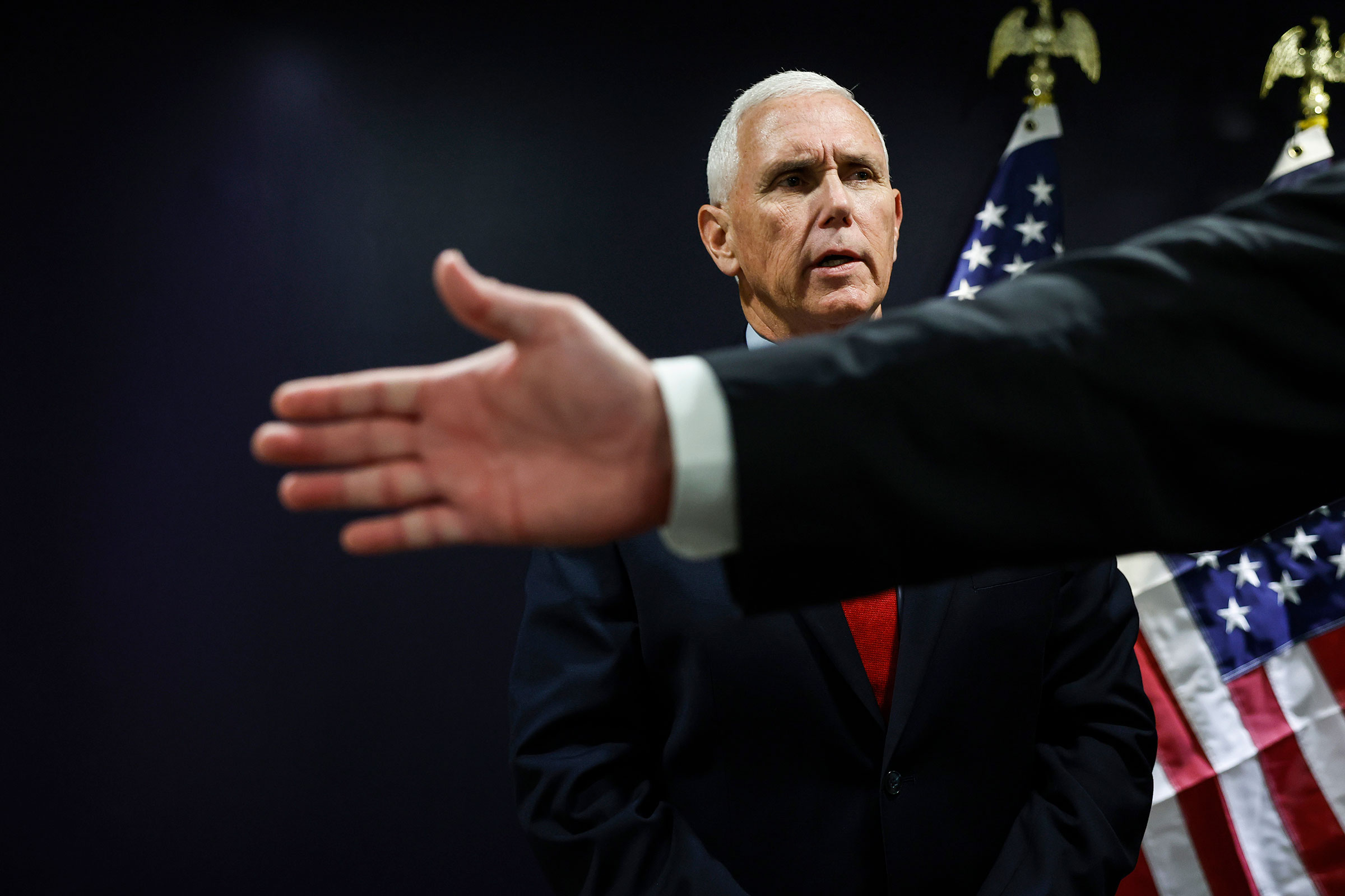 An aid for Republican presidential candidate, former Vice President Mike Pence holds out his hand as reporters arrive to speak with Pence after his remarks at the Pray Vote Stand Summit at the Omni Shoreham Hotel on September 15, in Washington, DC. 