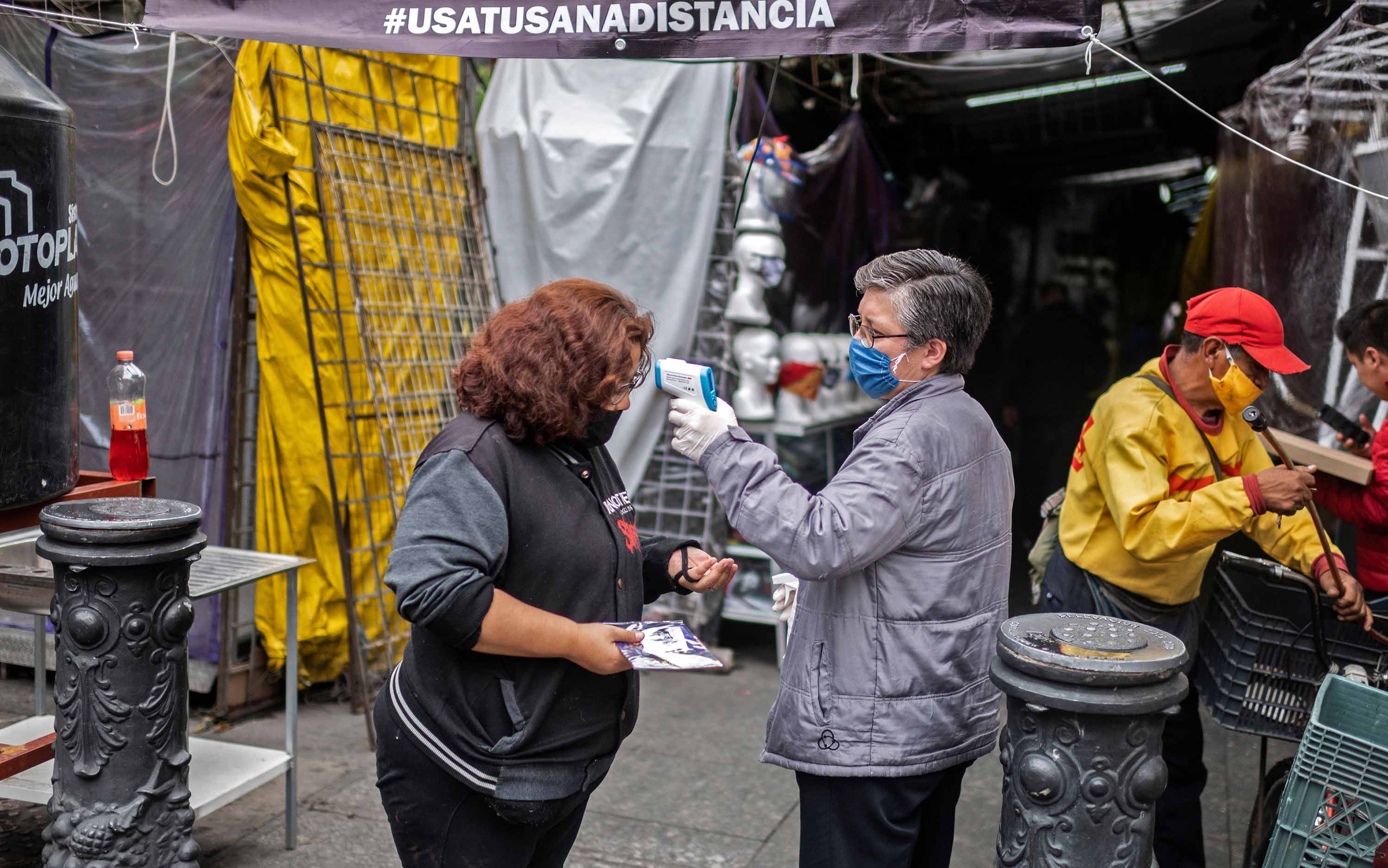 A woman has her temperature checked at Iztapalapa market, in Mexico City, on June 22.