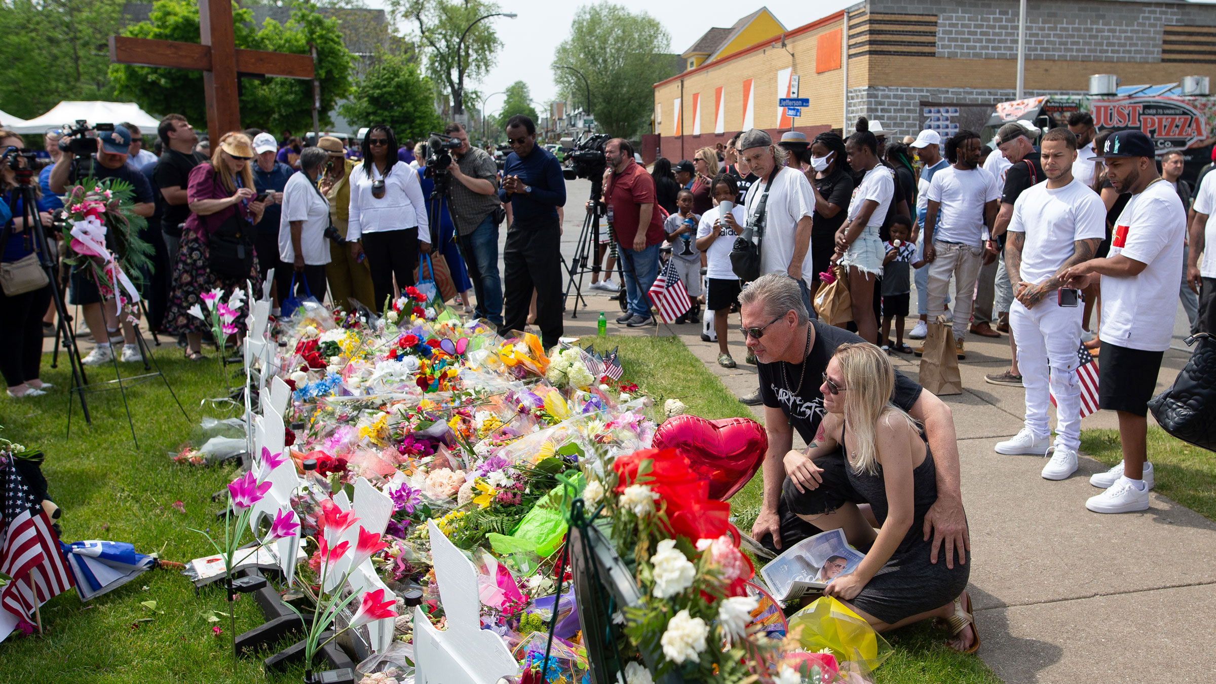 People visit a memorial May 21 for the victims of the Buffalo supermarket shooting.