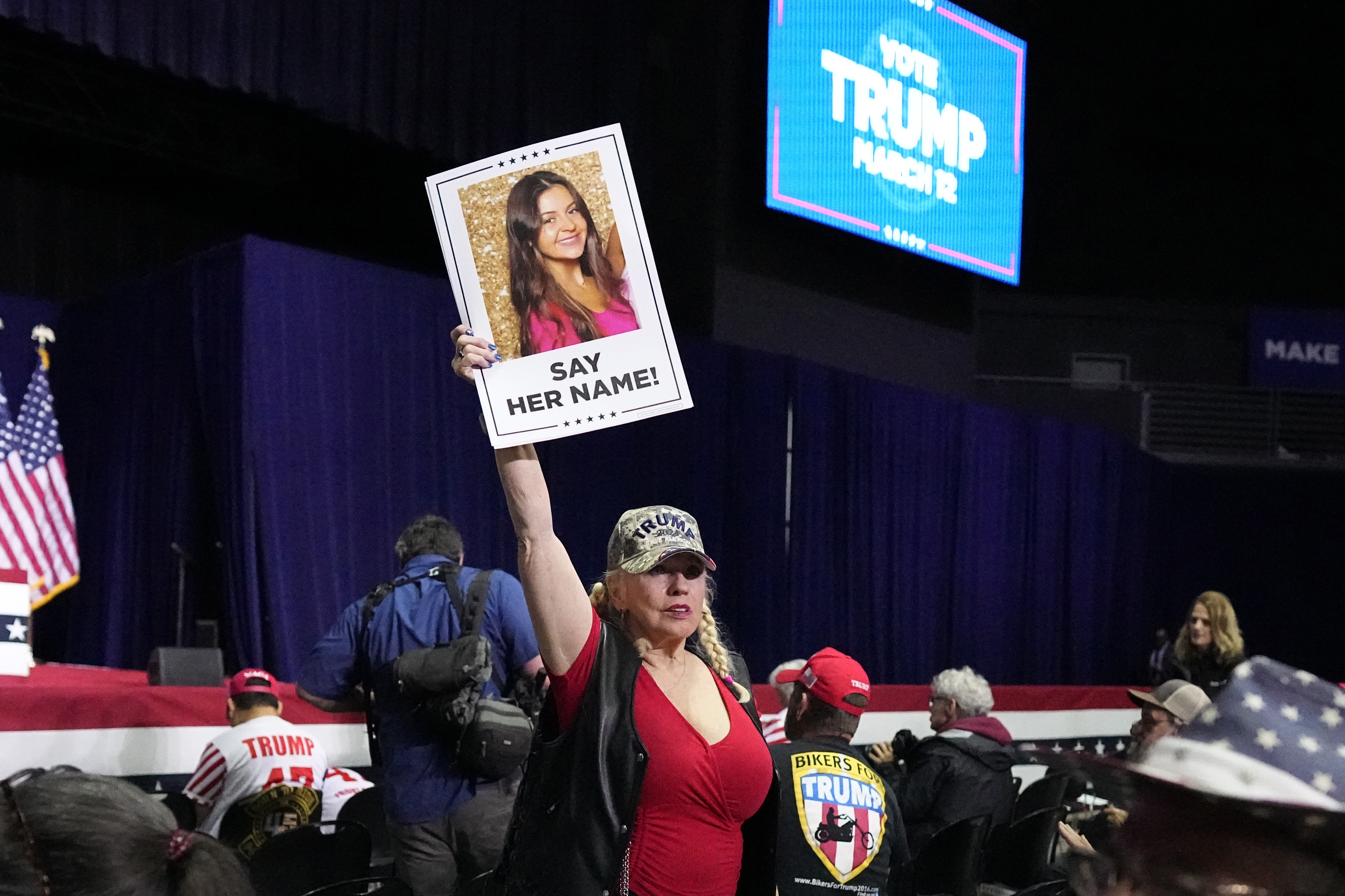 A supporter holds a sign with a photo of Laken Riley at a campaign rally for former President Donald Trump in Rome, Georgia, on March 9.