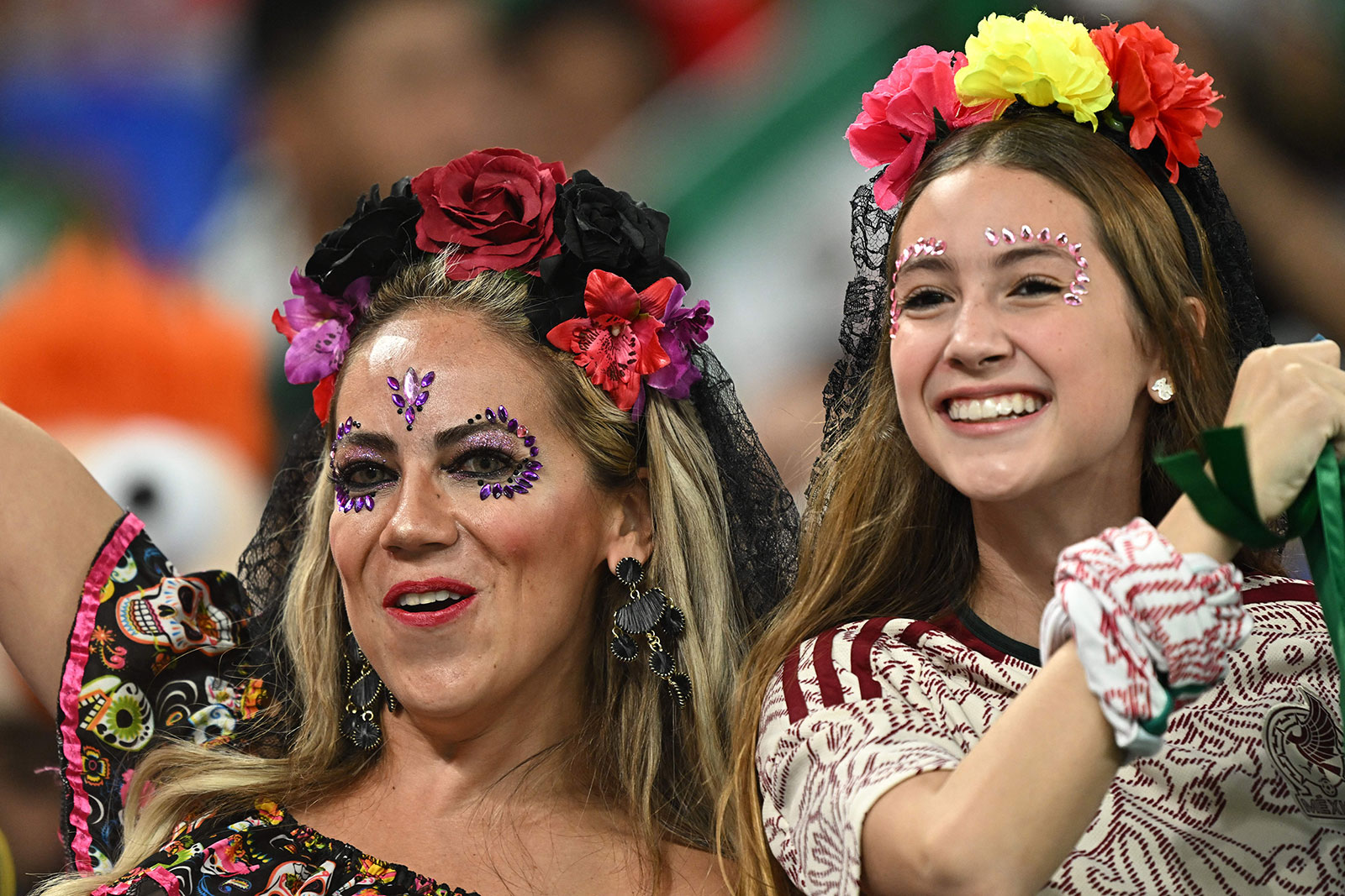 Fans cheer in the stands ahead of the match between Mexico and Poland on November 22.