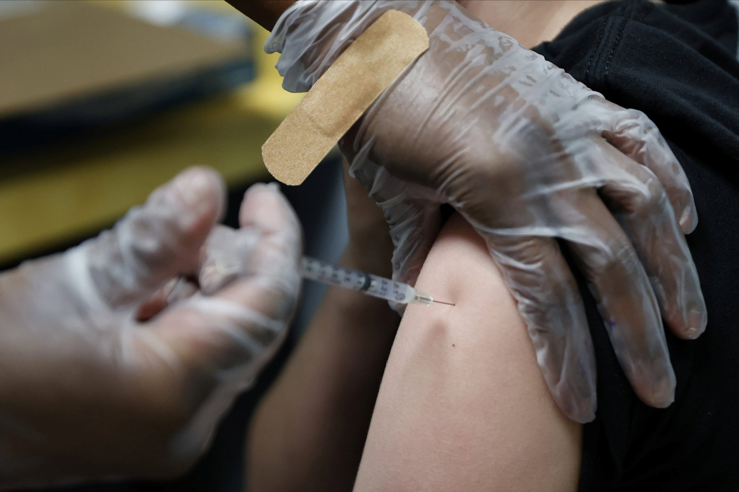 A teenager is inoculated with Pfizer's vaccine against Covid-19 at Dekalb Pediatric Center in Decatur, Georgia, on May 11.