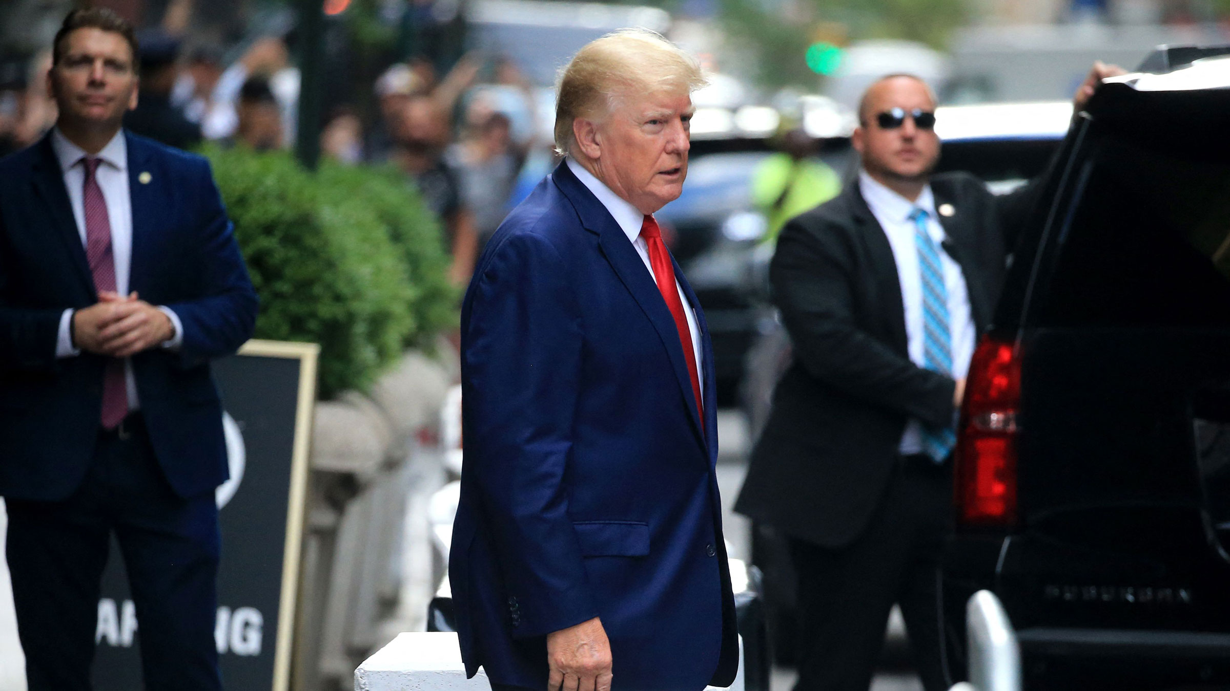 Former President Donald Trump walks to a vehicle outside of Trump Tower in New York in August.