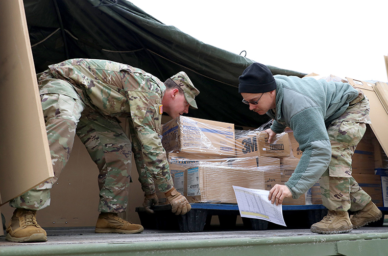  Iowa Army National Guard members unload medical supplies on Tuesday, March 24, in Poca, West Virginia. 