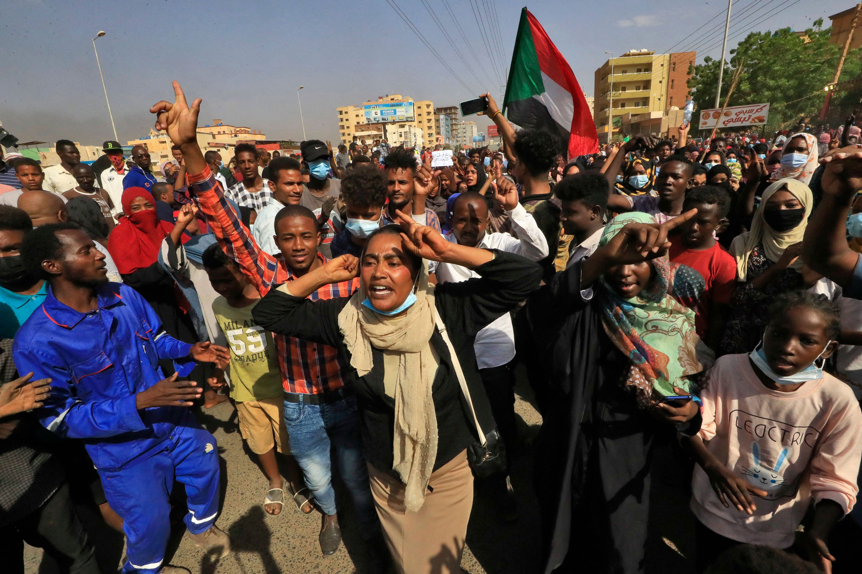 Protesters march on 60th Street in Khartoum, Sudan, on October 25, to denounce detentions by the military of members of Sudan's government.