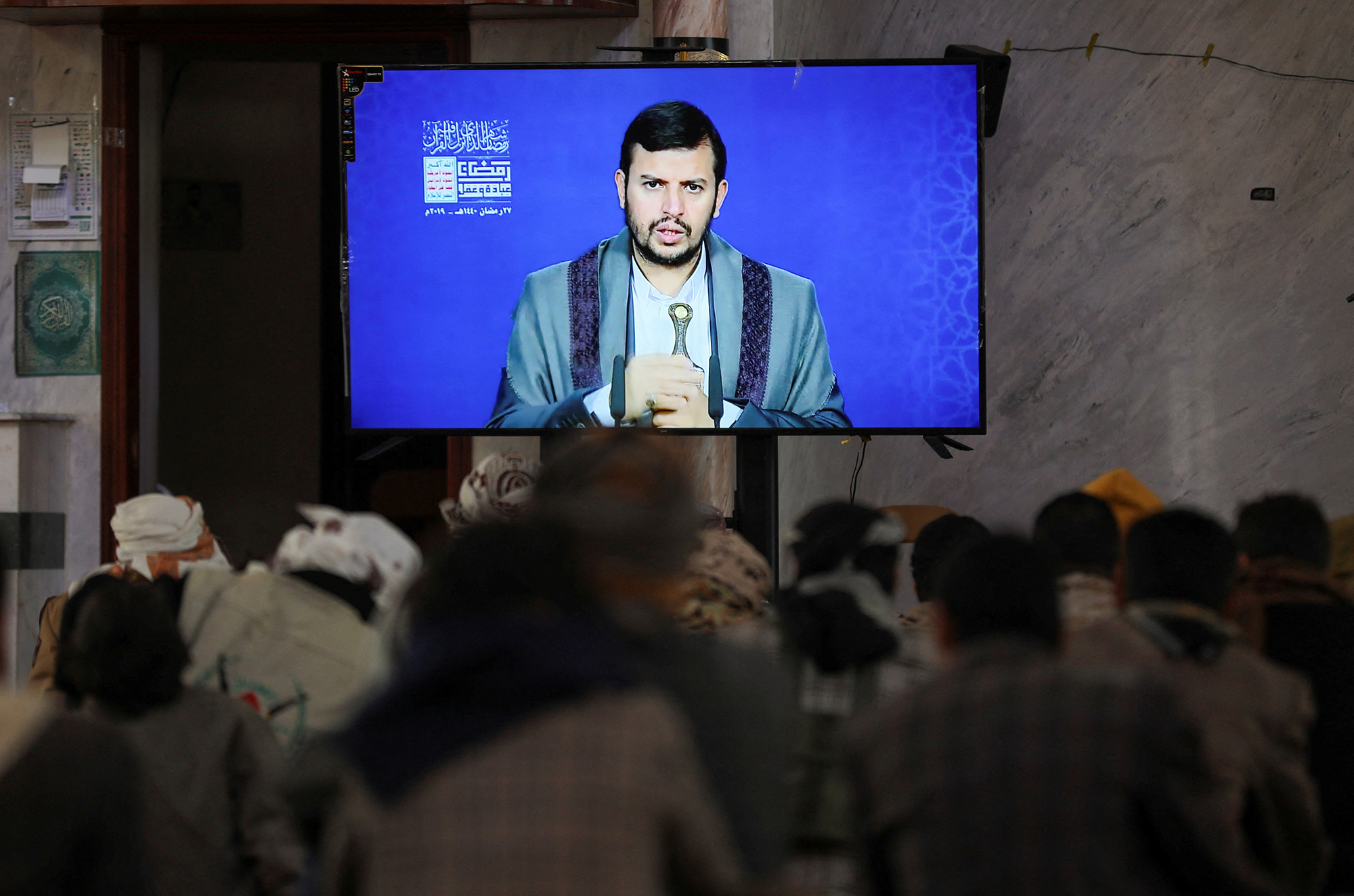 Newly recruited Houthi fighters watch a recorded lecture on Israel and the Jews by the Houthi movement's top leader, Abdul-Malik al-Houthi, during a ceremony at the end of their training in Sanaa, Yemen, on January 11.