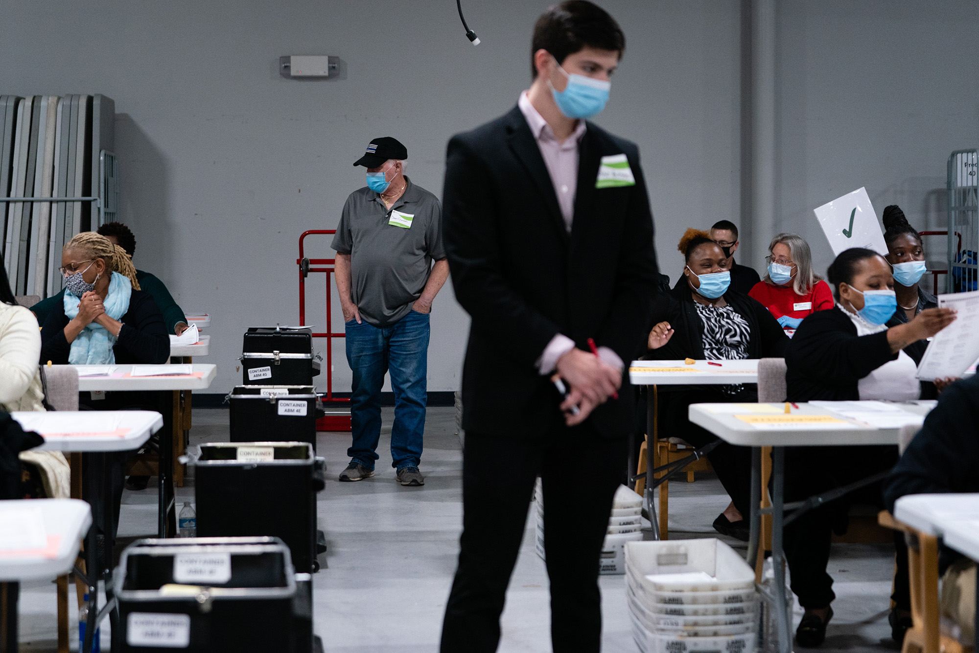 Political party representatives monitor people hand counting 2020 Presidential election ballots during an audit at the Gwinnett County Voter Registration office in Lawrenceville, Georgia, on Friday, November 13, 2020. 