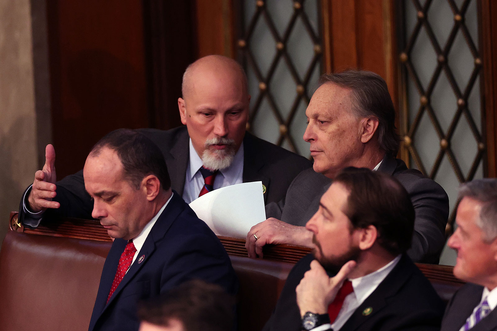 Rep. Chip Roy, second left, talks to Rep. Andy Biggs during the fourth day of elections for Speaker of the House on January 6, 2023.