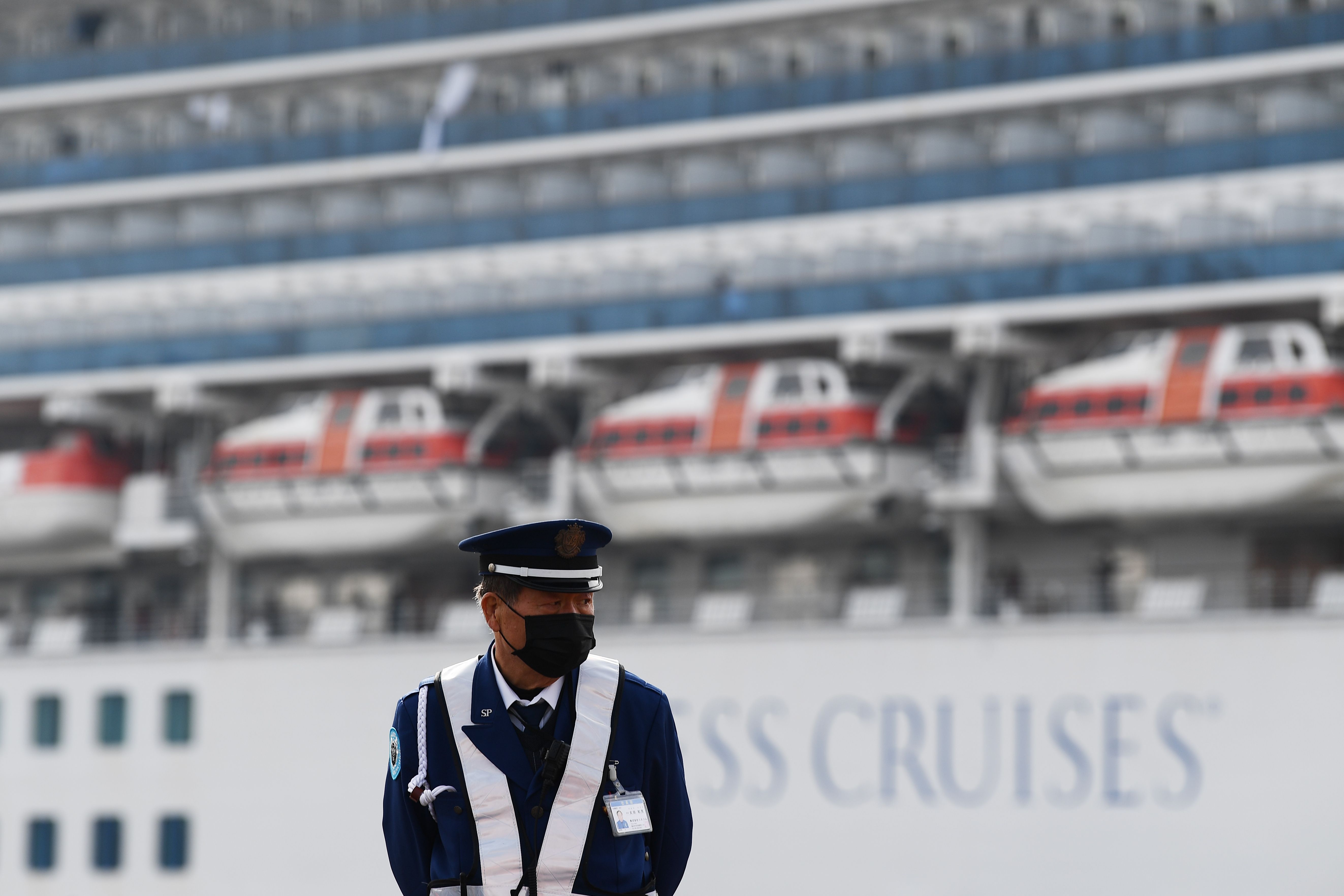 A security guard is seen in front of the Diamond Princess cruise ship at the Daikoku Pier Cruise Terminal in Yokohama port on Feb. 14.