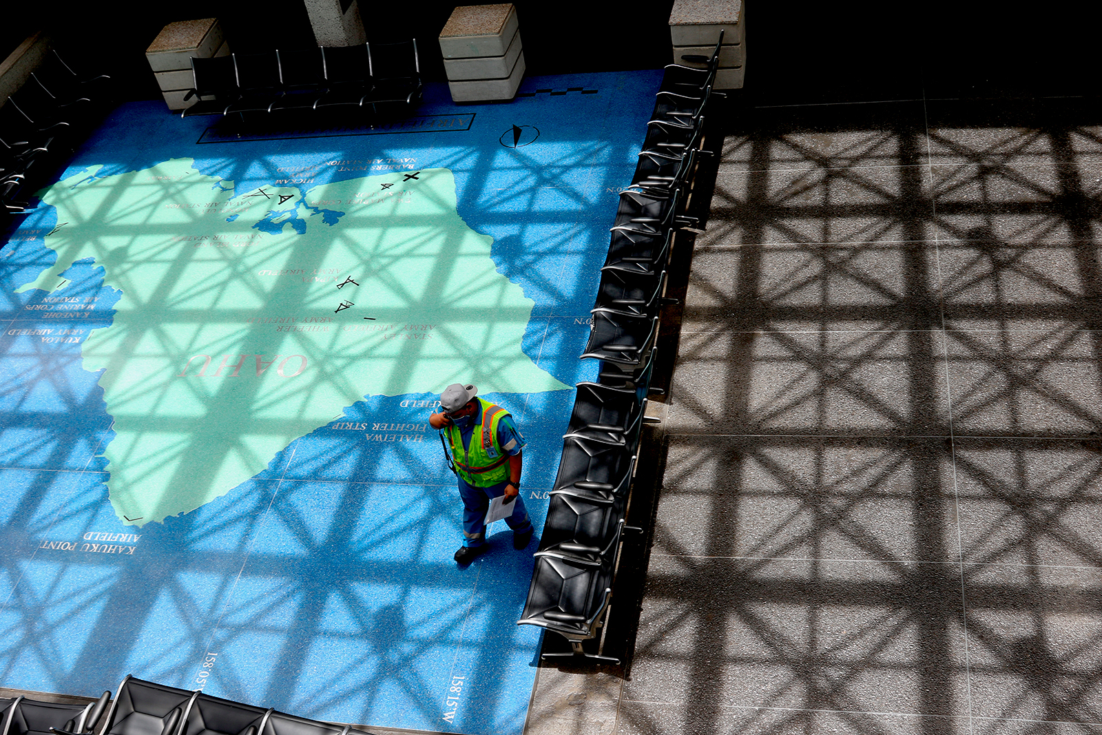 A man stands in an empty waiting area at the international airport on April 21 in Honolulu, Hawaii.