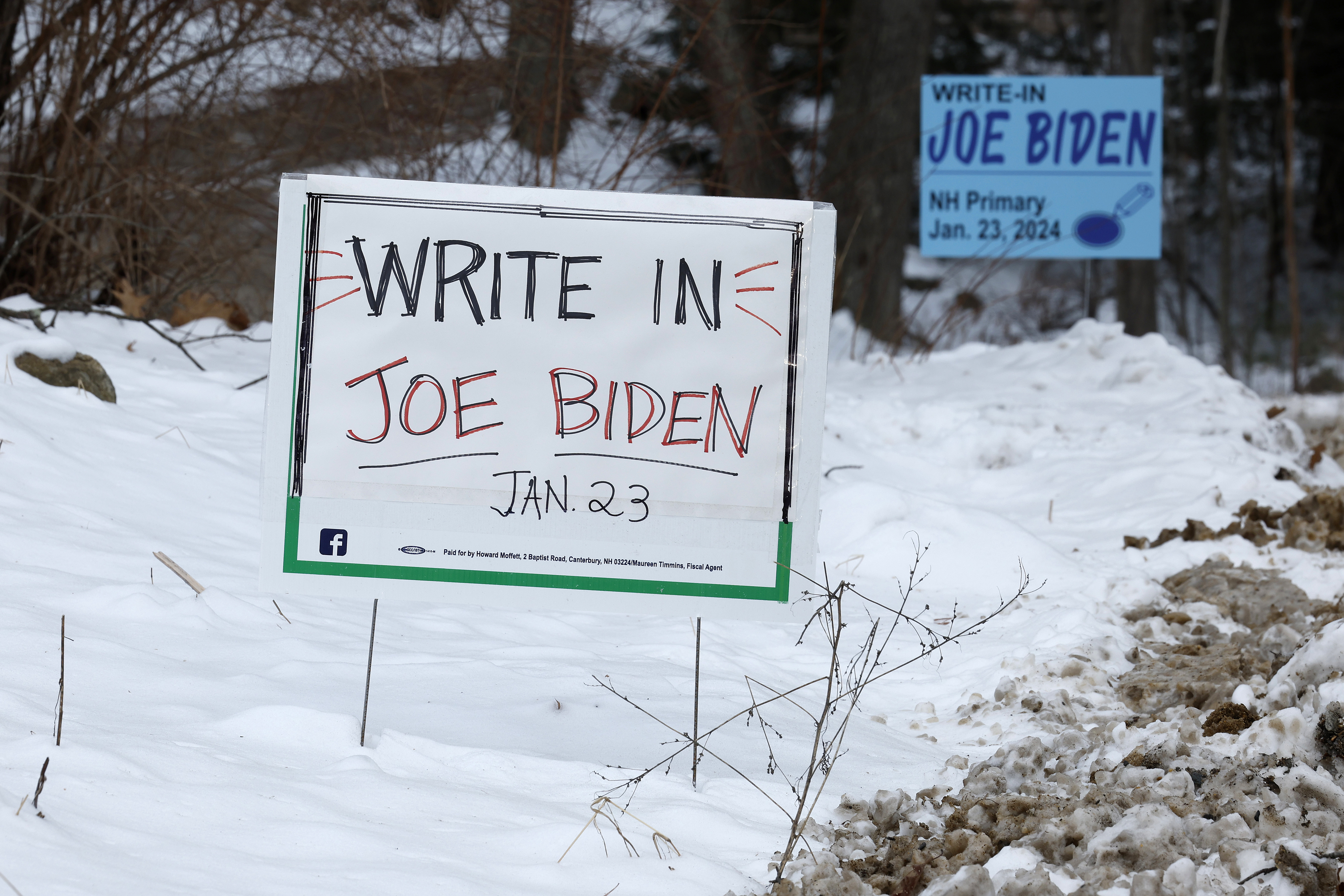 Campaign signs asking voters to write in President Joe Biden in the New Hampshire primary election stand along the road in Loudon, New Hampshire, on January 19.